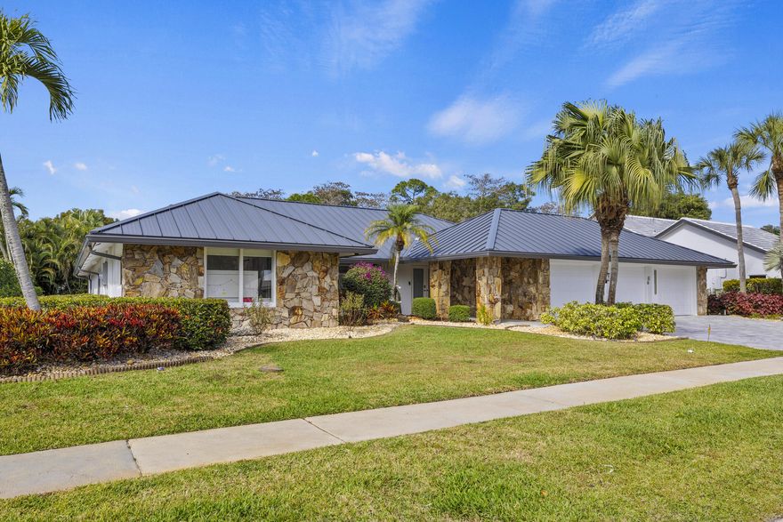 Completely renovated home in Boca Woods Country Club, offering a bright, spacious open layout with stunning private golf views. Features include a metal roof, impact windows and doors, porcelain tile throughout, and a sleek modern kitchen with two sinks and new high-end appliances. The home offers two large primary suites, two additional guest bedrooms, and three and a half beautifully redesigned modern bathrooms. Enjoy one of the largest screened patios in the community with a huge pool, screen enclosure, and marble pavers throughout. Three-car garage with epoxy floors and A/C. Modern lighting and new ductwork. Truly move-in ready.