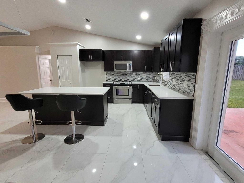 Photo of 7605 Woodland Creek Lane, Lake Worth, FL 33467 (MLS # R10976194)