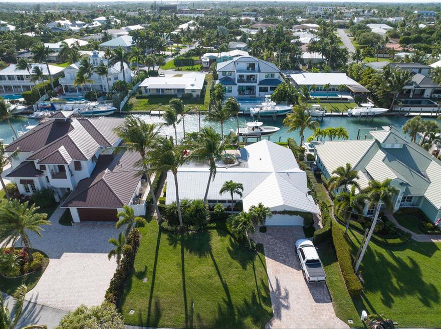 Accepting Back up offers!!  Great opportunity. Waterfront in Tequesta.  Go out back to your boat on the 16,000 Lb boat lift, drop in the water and be into the ocean in minutes.  Located 1 canal from the blue waters of the Intracoastal waterway in Tequesta, this home is a boaters dream with 3 - 4 ft of water depth at low tide, a beautiful custom heated pool, covered sitting area and built in grill. This home boasts a 3 bedroom split floor plan, gourmet kitchen with a gas range and 2 car garage. Recently remodeled and professional designed, this home comes turnkey with high-end mid century type furniture, flat screen tv's and more.  Bring your boat and enter your paradise.