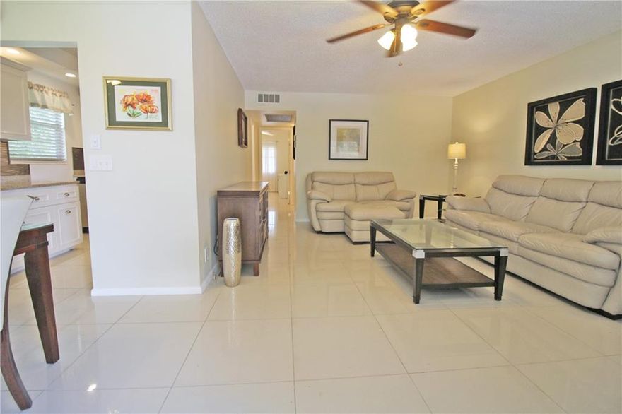 LIGHT & AIRY CORNER UNIT WITH UPDATED KITCHEN!! YOU WILL LOVE THE FEEL OF THIS BRIGHT 2 BEDROOM, 1.5 BATH CONDO AS SOON AS YOU STEP INSIDE!! LARGE PORCELAIN TILE THRU-OUT!! NO POPCORN CEILINGS HERE!! LOVELY UPDATED KITCHEN WITH RECESSED LIGHTING, GRANITE COUNTERTOPS, AND NEW STAINLESS STEEL APPLIANCES!! THE A/C IS BRAND NEW!! UPDATED BATHROOMS AND FULLY FURNISHED!! YOU WILL LOVE THE QUIET LOCATION NEAR WEST GATE, AND THE BEAUTIFUL GARDEN VIEW FROM YOUR ENCLOSED PATIO!! CENTURY VILLAGE EAST IS A 55+ COMMUNITY WITH FREE TRANSPORTATION INSIDE AND OUT!  THE GATED COMMUNITY ALSO FEATURES A FABULOUS CLUBHOUSE WITH CLASSES, CLUBS, FREE MOVIES, BROADWAY SHOWS & STATE OF THE ART GYM! CLOSE TO THE BEACH, SHOPPING, MAJOR HWYS AND GREAT RESTAURANTS! ASSOC. CLAIMS 55+