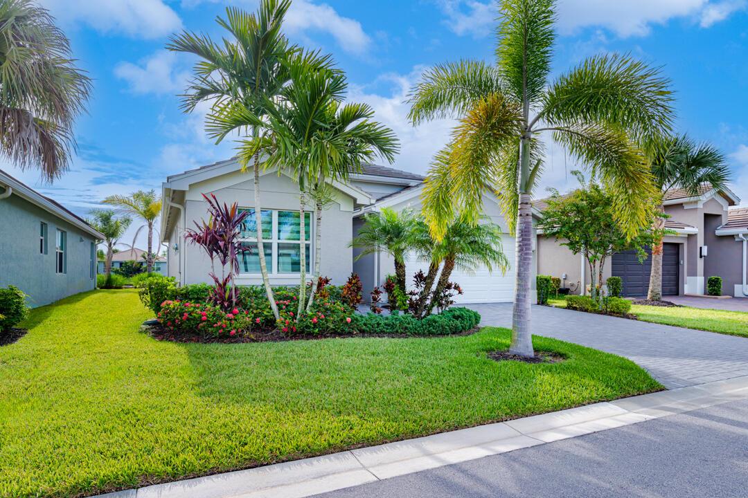 Discover the epitome of contemporary living, nestled in the vibrant& active 55+ community of Riverland in Port St. Lucie, FL. This stunning 2-bedroom+flex room, 2-bathroom home offers 1,716 square feet of thoughtfully designed living space, perfectly complemented by breathtaking eastern lake views from this meticuluous CONTEMPORARY Heron. Numerous special features & upgrades, including WHITE GOURMET KITCHEN w/soft close cabinets.NO CDD FEES! Quarterly HOA fees access all amenities, Cay Social Clubhouse offers heated pool, new cafe, pool bar, social event room & game rooms. The Sports& STATE OF THE ART Fitness Center has multiple pools, tennis, pickleball, bocce. Enjoy classes, concerts& a green market at the Arts&Culture Center, or explore the closeby medical facilities,restaurants&stores