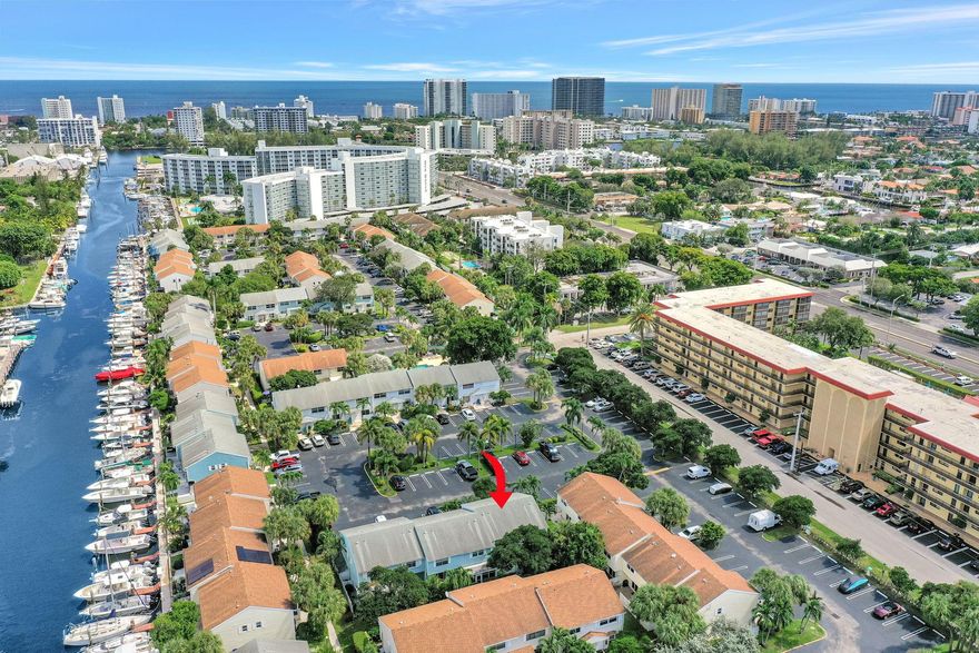 Welcome to a rarely available corner TH * 1 mi from the beach * Sun Harbor is perfectly placed on an inlet to the Intracoastal. This bright home offers an ideal blend of coastal charm & modern updates * 2 primary en-suite bedrooms w/ample closet space. An open concept makes it easy for everyone to be a part whether you're in the kitchen, living or dining area. Pristine black stainless appliances, sleek counters, ceramic tile downstairs & laminate on steps & 2nd fl. Travertine bathrooms, front loader washer & dryer, hurricane shutters & many more extras. Enjoy a private wood deck patio w/extra corner footage, ideal for outdoor dining, lounging, or cleaning all the fish you just caught.  Move-in-ready…all just minutes from the beach, shopping, dining, and everything the coast has to offer.