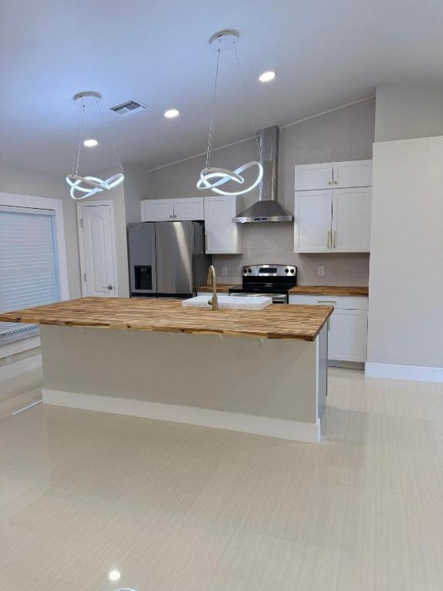 Stunning fully remodeled 3 bed, 2 bath Cape Coral home with 2024 roof! Enjoy a brand-new kitchen with all new appliances, sleek tile flooring throughout, and modern LED lighting. Both bathrooms are fully updated with undercabinet lighting; the primary suite boasts dual showerheads. Energy-efficient impact windows provide peace of mind. Spacious 2-car garage with epoxy flooring. No HOA, and plenty of room to park your boat or RV—or even add a pool! This move-in-ready gem blends style, comfort, and future potential.