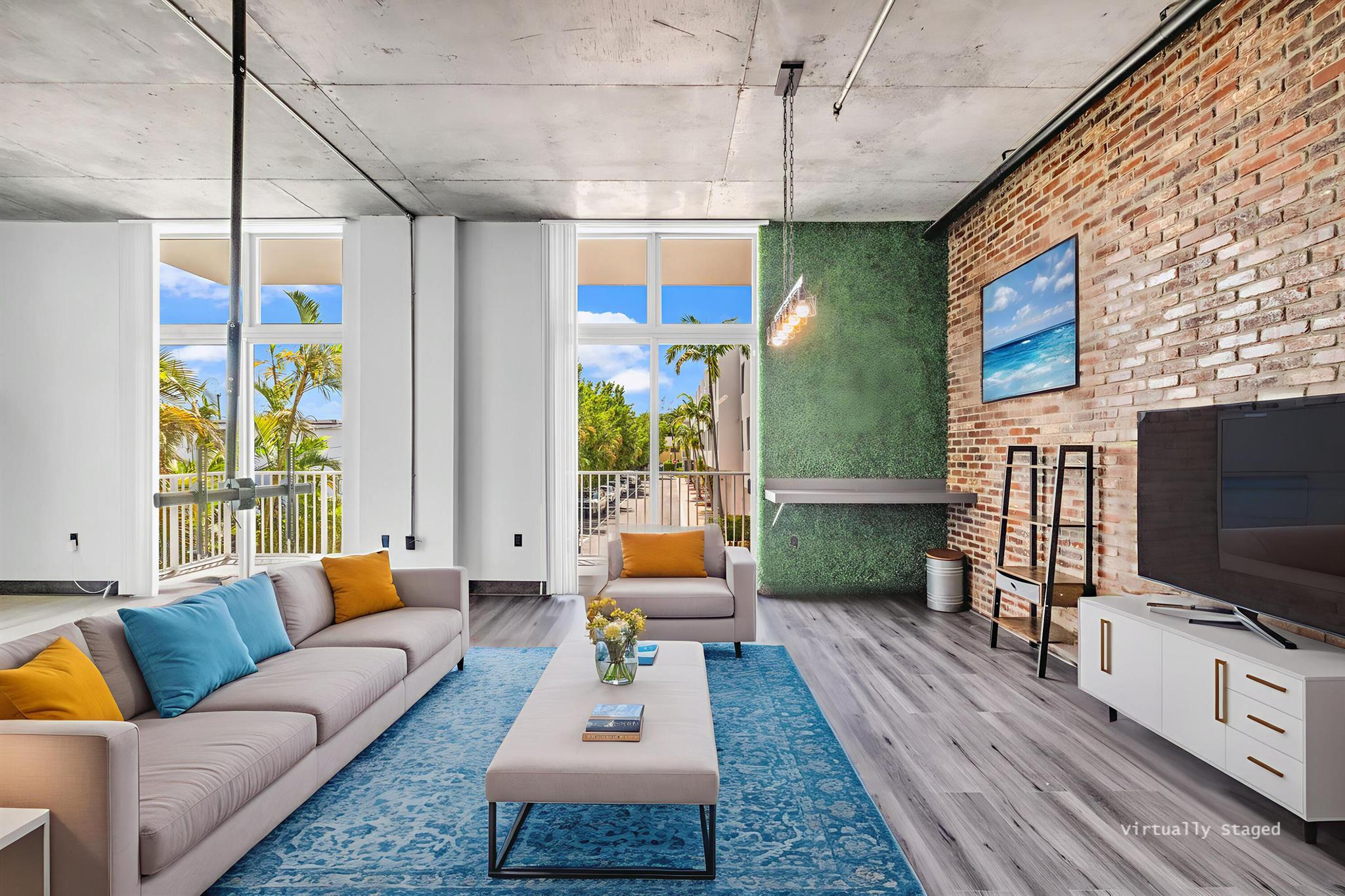Unique New York Loft style in Florida! One-of-a -kind. This beautiful open concept loft blends industrial-inspired design with urban convenience. Fully customized, including a new floor with two color combination, exquisite bathroom with dual sink, a wood wine bar, real brick walls, updated lighting fixtures, concrete ceiling with exposed pipes connections, and special custom-made furniture INCLUDED. Extensive private balcony perfect for relaxation and entertainment. Building amenities: Pool, private assigned parking, storage, etc. PETS allowed! Located in the heart of Hollywood, just walking distance to restaurants, shops, parks, and only a bike ride away from Hollywood Beach and boardwalk. Live the New York lifestyle for a quarter of the price! (Short-term rental appv, 3 months minimum)