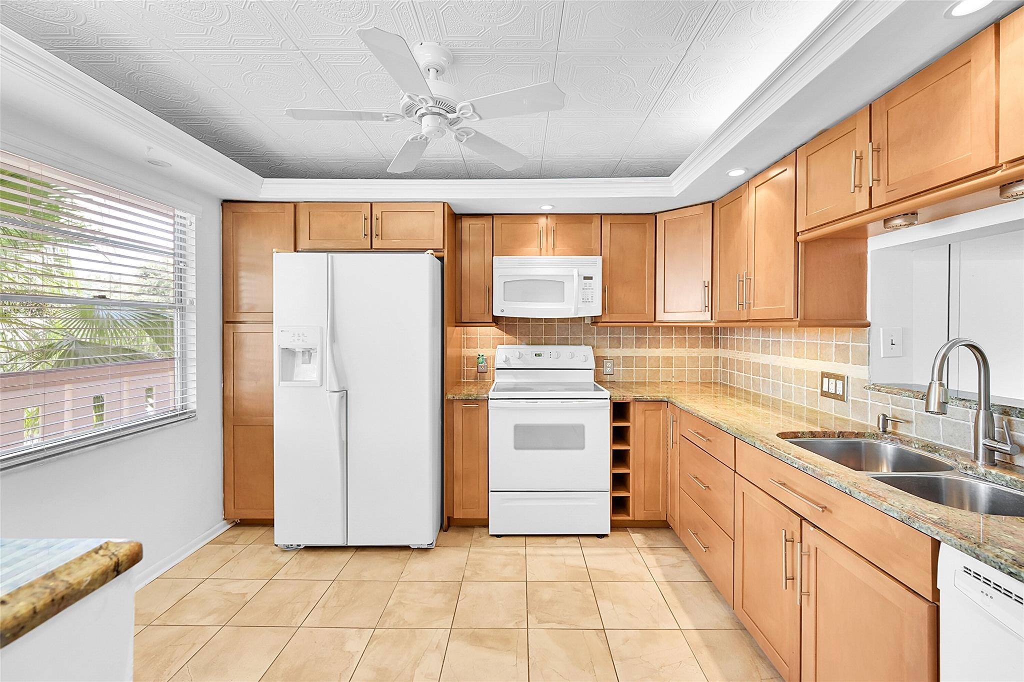 This property features a remodeled kitchen and bathrooms that include a tankless water heater, knockdown ceilings (no popcorn), granite countertops, and new white kitchen appliances, updated open kitchen ceiling. Carpeting is limited to the primary bedroom, which also boasts a custom closet. Primary Bathroom Whirlpool Tub/Shower. The south-facing patio offers tile flooring and receives ample sunlight. The air conditioning unit was installed in 2010. Please note that one occupant must be 55 years or older, with a good income and a FICO score required by the association. All assessments have been paid. Additionally, Antigua has an income requirement of 3x making it easier than other associations to qualify for condo approval. ONLY ONE CAR PERMITTED SENIORS 55+ PARK IN #103 OR GUEST PARKING