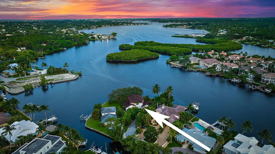 Welcome to your dream waterfront retreat on the picturesque Loxahatchee River. This exquisite point lot estate boasts over 200' of pristine waterfrontage, offering unparalleled views and a serene, private setting. The property is graced with majestic oak trees that create a tranquil, shaded ambiance. Inside, you'll find a thoughtfully designed layout featuring 4 spacious bedrooms and 3.1 baths. The primary suite, conveniently located on the first floor, provides a serene sanctuary with stunning river views. Embrace the ultimate in waterfront living with this exceptional home, where every day feels like a vacation.