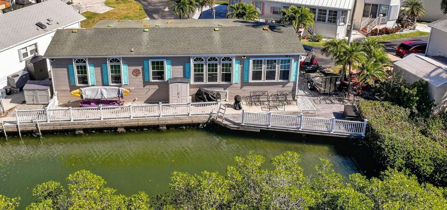 Coastal glamour meets boater's paradise in this remodeled 2BR/2BA + office retreat with a 50' private dock and direct Intracoastal access right from your backyard. The stylish eat-in kitchen features quartz countertops, an oversized island, crisp white cabinetry, and new stainless steel appliances. Two paver driveways offer added convenience. Located within gated ocean resorts on North Hutchinson Island with resort-style amenities including pool, marina, boat ramp, tennis, bocce, shuffleboard, dog park, and private beach access. Ideal as a seasonal escape, investment property, or full-time residence, just minutes to downtown Fort Pierce and Vero Beach dining, culture, and entertainment