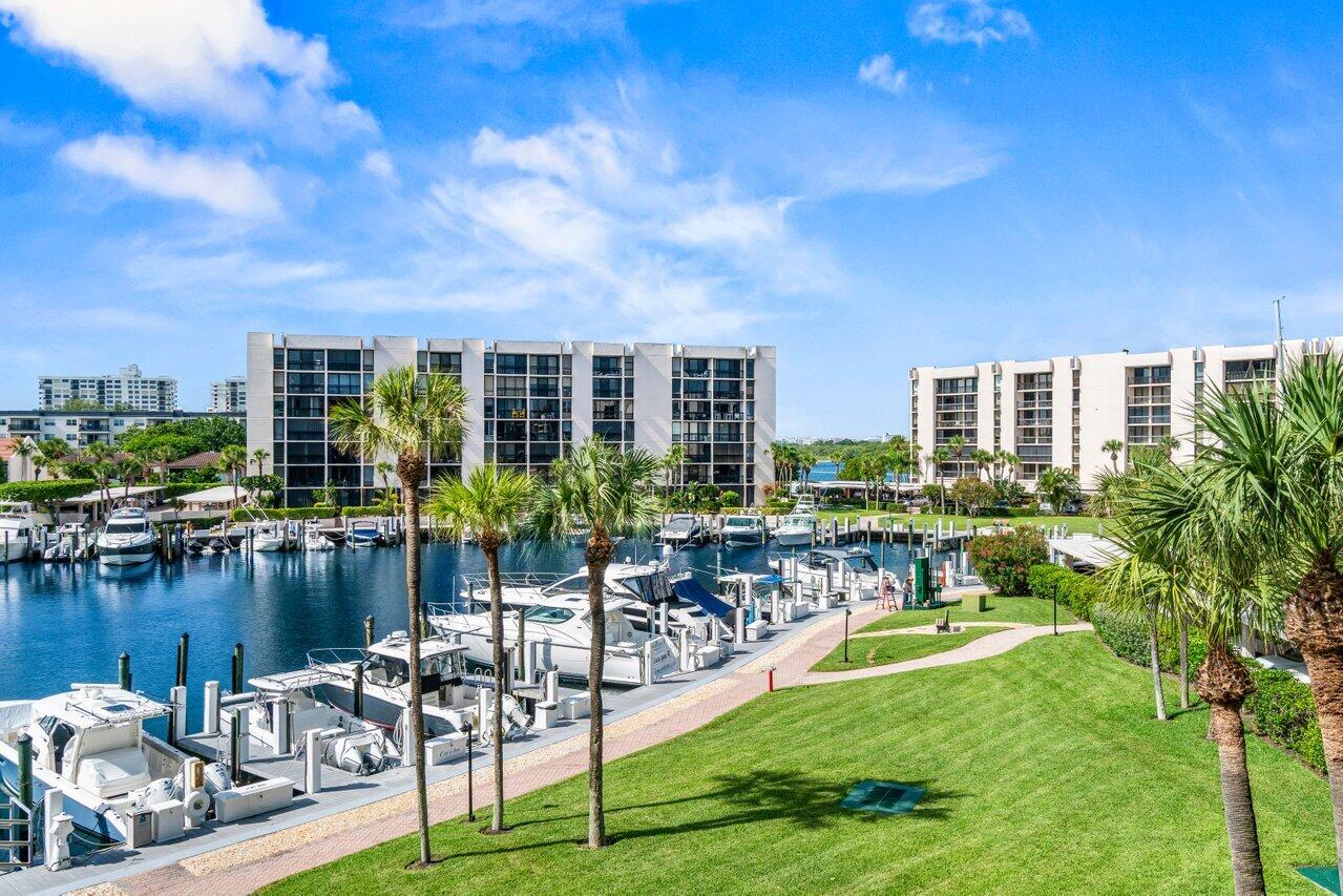 Experience breathtaking southern marina views from this beautifully renovated 2-bedroom, 2-bathroom residence located in the exclusive Yacht & Racquet Club of Boca Raton -- one of the area's premier private waterfront communities. This light-filled unit features elegant neutral tile flooring throughout and an updated gourmet kitchen outfitted with granite countertops, a striking glass subway tile backsplash, custom white cabinetry, and a full suite of stainless steel GE appliances. Crown molding adds a refined touch to every room, while hurricane-impact windows and doors provide security, efficiency, and peace of mind. Additional upgrades include a new electrical panel and a covered carport space (#53) for your convenience.