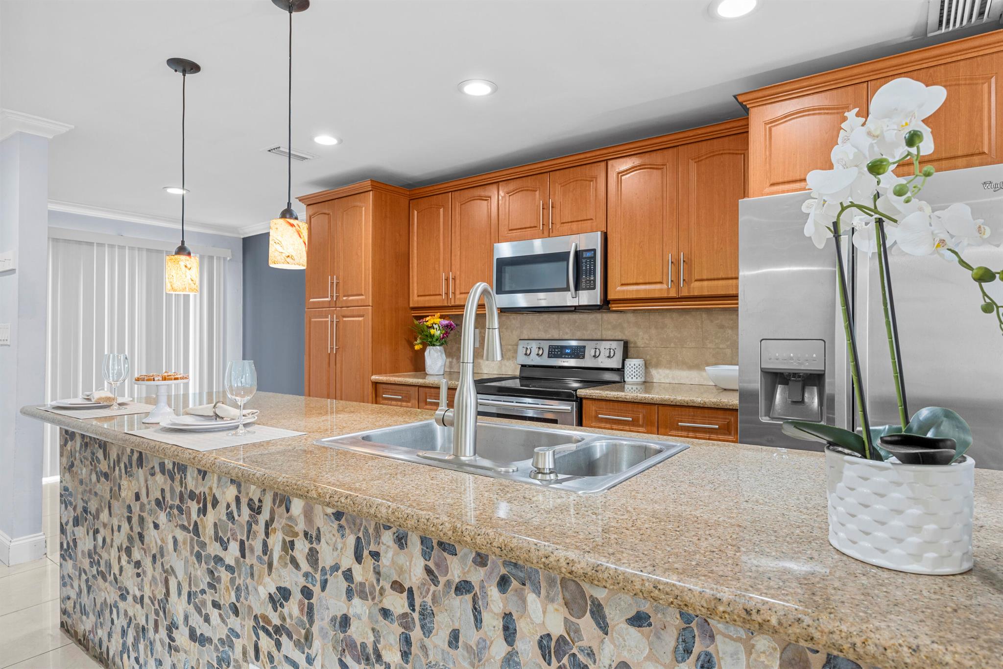 Welcome to this spacious 4 bedroom, 2.5 bath townhome in the highly sought after Townhomes at Jacaranda, located in one of the best areas of Broward. The garage has been converted into a fifth bedroom with a closet, while still providing additional storage space. Enjoy the convenience of a half bathroom located downstairs and a dedicated laundry area with a full size washer and dryer. Beautiful tile floors flow throughout the bright, open living spaces featuring stainless steel appliances. The large master suite includes a walk-in closet and an en suite bathroom. Step outside to a fenced backyard perfect for grilling and entertaining, just steps from the community pool and playground. Close to Broward Mall and Sawgrass Mills, this home offers comfort, convenience & unbeatable location!