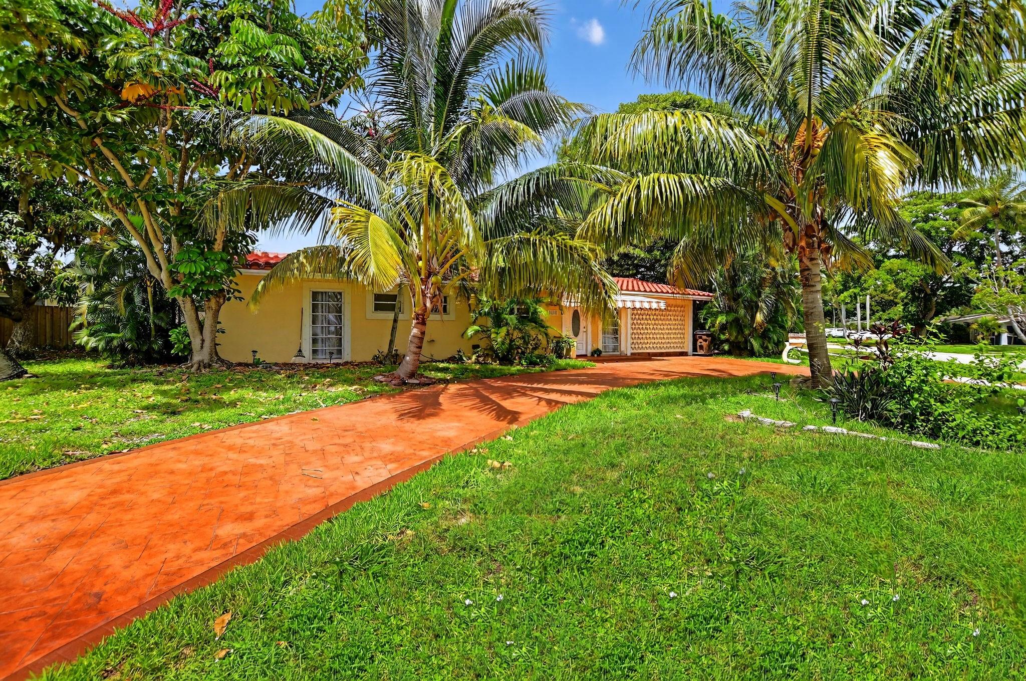 Live the Beach Life in The Cove – No HOA!
Just five blocks from the sand, this 3-bed, 2-bath home sits on a lush corner lot in one of Deerfield Beach’s most desirable neighborhoods. Walk or bike to the pier, boardwalk, restaurants, and shops—everything you love about the coastal lifestyle is right here. Enjoy mango, bamboo, and banyan trees surrounding your private oasis. Inside, floor-to-ceiling windows fill the space with natural light. Recent 2025 upgrades include a terracotta tile roof, quartz countertops, and a custom circular driveway. No HOA—just freedom and tropical charm.