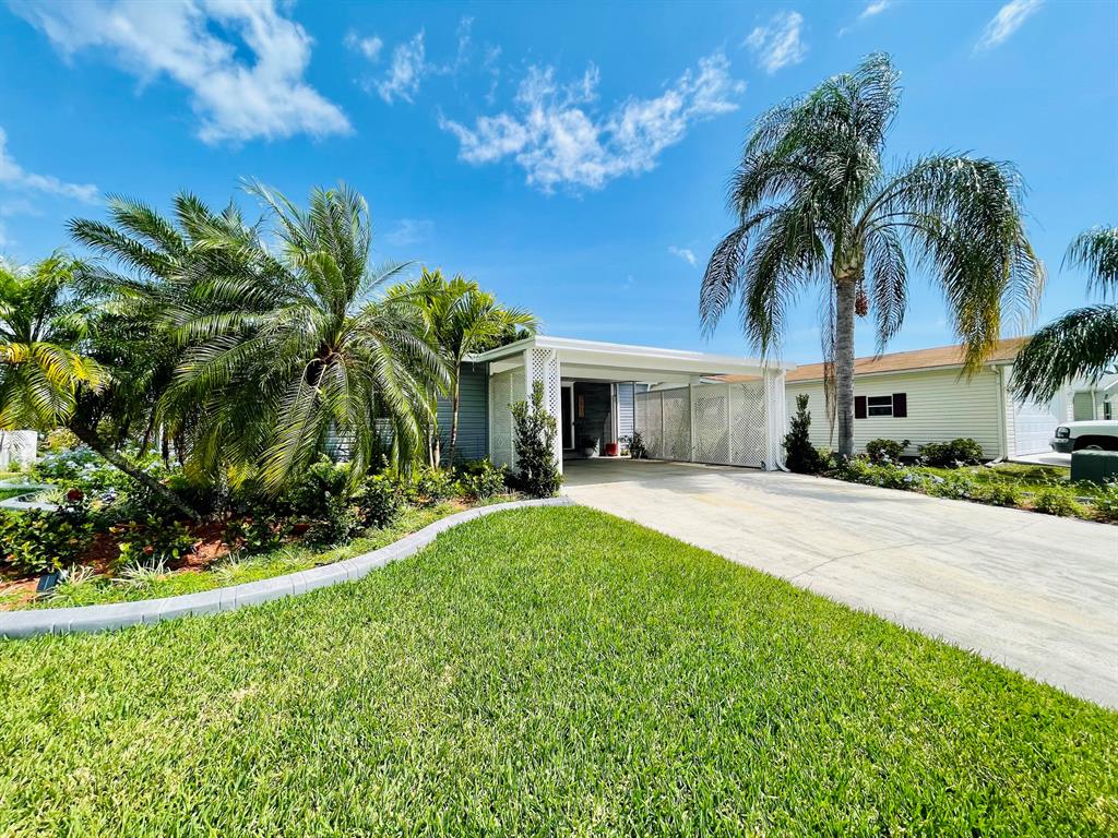 Luxurious living in the most desired, amenity packed 55+ community on the Treasure Coast. This Sand Dollar model offers a split plan with sleek designer updates thru-out including new shaker kitchen cabs with soft close doors, drawers, slide outs, quartz and wood countertops, remodeled laundry/utility area, coffee station, porcelain tiled and lam. floors, tiled master and guest bath with custom frameless glass surrounds, 2022 Roof, tiled lanai, full wood trim, mouldings, doors and plantation shutters, recessed LED lighting and designer fans and light. Home is surrounded by lush landscape, concrete curbing and sold furnished. All measurements approximate, buyer to verify.