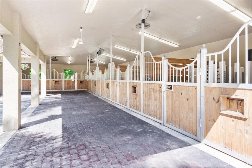 Charming 2 acre equestrian property featuring a 4 bedroom pool home.  This property is located on a very quiet loop of the Saddle Trail. The barn totals 7 stalls, A/C tack room.  Each stall is equip with  high powered fans, auto fly spray, and matted stalls. The L-shaped aisle has rubber brick pavers and there is a 2-bay covered wash rack. The arena is irrigated and has a fiber footing mix that measures approximately 190'x 90'.