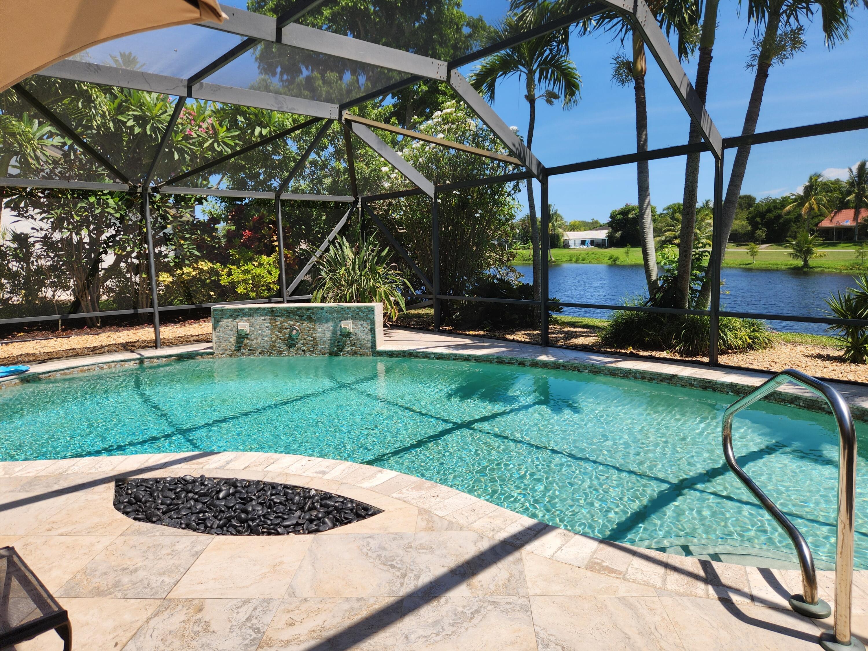 Enjoy million-dollar lake views from this beautifully maintained 3-bedroom, 2 1/2-bath pool home with an additional den, located in Delray Beach's #1 neighborhood. Perfectly situated on the Sherwood Park Golf Course, this property offers golf enthusiasts a prime location with no membership requirements, ideal for those who love to play without commitment.The split floor plan features a formal living and dining room that opens to a screened pool and patio area, perfect for relaxing or entertaining. The updated kitchen boasts wood cabinets, granite countertops, and stainless-steel appliances. The spacious master suite includes a California closet, a sitting area, and a luxurious bath with a Jacuzzi tub, double-sink vanity, custom lighting, and a glass-enclosed shower.