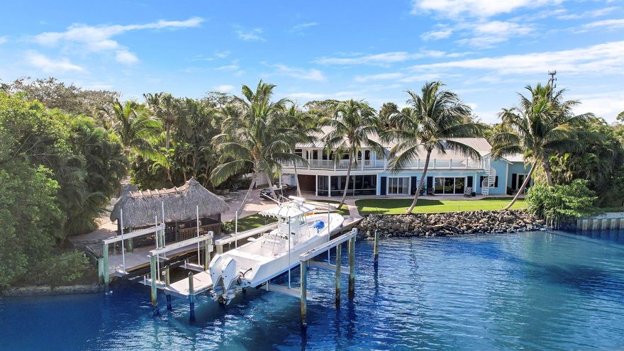 THIS IS A MUST SEE LUXURY HOME! Escape to Paradise! Spectacular sunrises and Amazing direct Intracoastal views from this one-of-a-kind Key West style pool home. Renovated with impeccable taste, the main house has 4 bedrooms & 3 full baths with the Owner's suite, kitchenette & 400 sq. ft of sundeck upstairs. The separate 1/1 guest house has breathtaking views as well! This home features over 150+ feet of private Intracoastal frontage, 2 new docks, 2 new boat lifts- 24,000 lbs & 16,000 lbs, You also have access to a community boat ramp. Screened Tiki-Hut, 500 Gallon Underground Gas Tank, Hardiplank Siding, Metal Roof, Summer Kitchen, Marble Floor, Tongue and Groove Ceilings, Limestone Countertops with Natural edge, High-End Kitchen Appliances, Walk-In Pantry and so much more