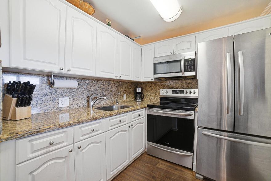 WATERFRONT 1 BEDROOM AND 1 AND A 1/2 BATHS WITH PATIO OVERLOOKING LAKE.CUSTOM STORAGE CLOSET BUILTINS IN PRIAMARY AND HALLWAY (PANTRY!)
TOTALLY REMODELED WITH MOHAWK WATERPROOF FLOORS , WHITE KTCHEN CABINETS WITH GRANITE COUNTERS, STAINLESS STEEL SINK WITH WATER FILTRATION SYSTEM,STAINLESS STEEL KITCHENAID FRENCH DOOR REFRIGERATOR, LG STAINLESS STEEL MICROWAVE , FRIGIDAIRE STOVE ,COMPLETELTY  NEUTRAL TILED WALLS IN PRIMARY BATH WITH FRAMELESS GLASS SHOWER DOORS , 2 FRIEDRICH REMOTE CONTROLLED AC UNITS (3 YEARS OLD). 7 INCH CROWN MOLDING THROUGHOUT, CUSTOM WOOD PLANTATIOAN SHUTTERS IN LIVING ROOMA AND PRIMARY BEDROOM, CUSTOM MDF PATIO STORAGE CABINET AND TINTED SLIDING WINDOWS ON SCREENED BACK  PATIO OVERLOOLKING LAKE  AS WELL AS TINTED PATIO SLIDERS, INVESTORS CAN RENT UNIT RIGHT AWAY.