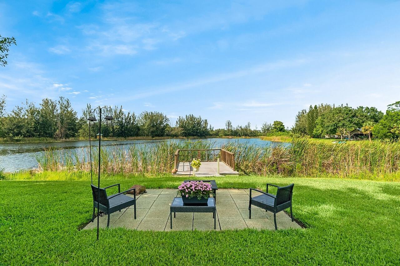 Waterfront Living at Its Best in Vero Lake Estates! Wake up to breathtaking, long lake views that feels like a million-dollar retreat without the price tag! Views of the lake from nearly every angle! This beautifully updated 3 bedroom, 2 bath, 2 Car garage home sits on a spacious and WIDE 87x145 or .29-acre lot with lush landscaping, new outdoor lighting, and a BRAND NEW ROOF for your peace of mind. Step inside the front door to light-filled living spaces w/ laminate and tile flooring thru out, and immediately see a beautiful huge Florida Room enclosed w/ walls of windows and the VIEWS leading to your private dock & outdoor nature ambiance. Additional paver stone seating area for fire pit or BBQ. Garden Shed already in place and lawn maintained w/ a 4 zone sprinkler system and new pump!
