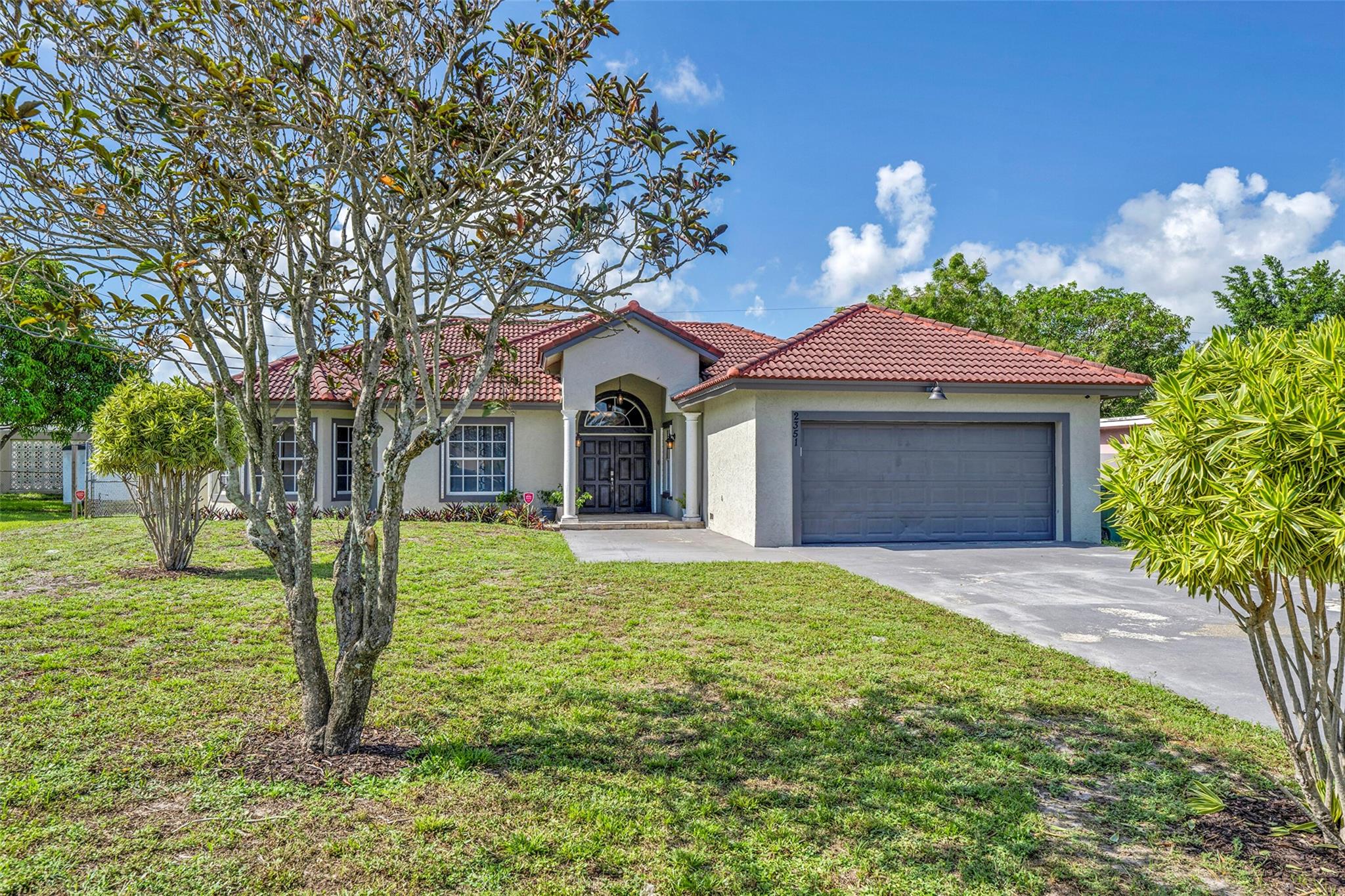 Welcome to this beautifully spacious 5-bedroom, 3-bath home . With a 2-car garage & a wide driveway that comfortably fits 4 additional cars, there’s no shortage of space . Inside, you'll find an ideal layout with generous living areas and an oversized primary suite that truly stands out. The primary bedroom features a luxurious en suite bathroom with a large walk-in shower, dual vanities, and 2 oversized closets offering both comfort & function. Step outside to enjoy the fenced backyard, perfect for relaxing, entertaining, or letting pets play. Located just minutes from shopping, major highways, airports, and downtown Fort Lauderdale, this home offers both convenience and a sought-after neighborhood lifestyle. Don’t miss your chance to own this move-in ready gem in Lakeside Estates!