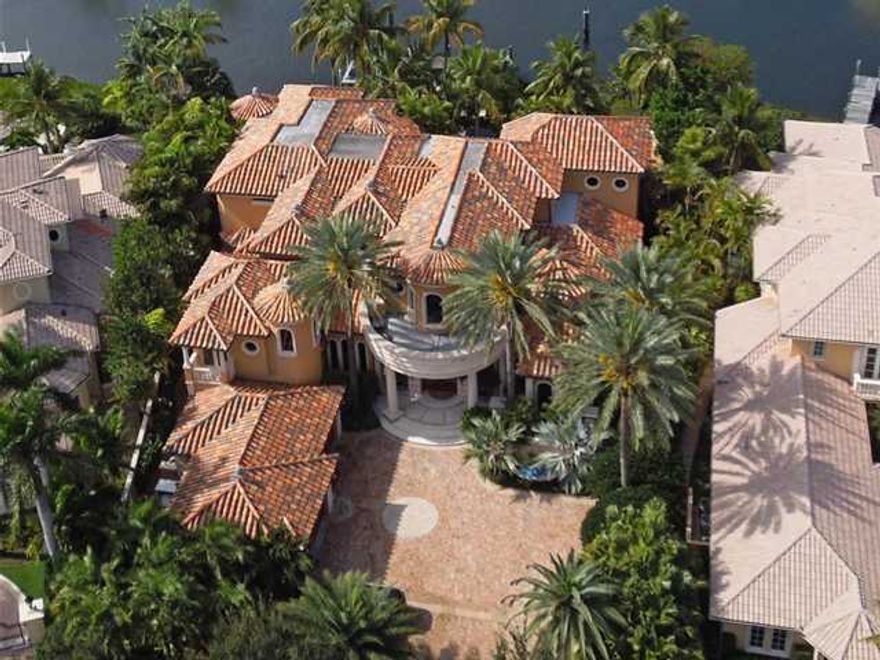 Discover opulence on 130 ft. of waterfront! Over 9,000 sq. ft. with flowing lines accented with exotic woods, walls of glass, Venetian plaster, intricate stone work, limestone floors, signature lighting, and power ceilings. ALL State-of-the-art! Lavishly appointed interiors are complimented by graciously proportioned rooms and fine architectural detailing. High tech security and state-of-the-art electronics take luxury to a new level of convenience. The two story foyer features an extraordinary floating stone and glass staircase. The massive 37x31 foot, two story living room has a hidden Media wall, a circular wet bar and tranquil views of the gorgeous lanai, rock waterfall and lushly lanscaped pool. The dramatic circular dining Room has a rounded wall... (see supplement for full remarks)
