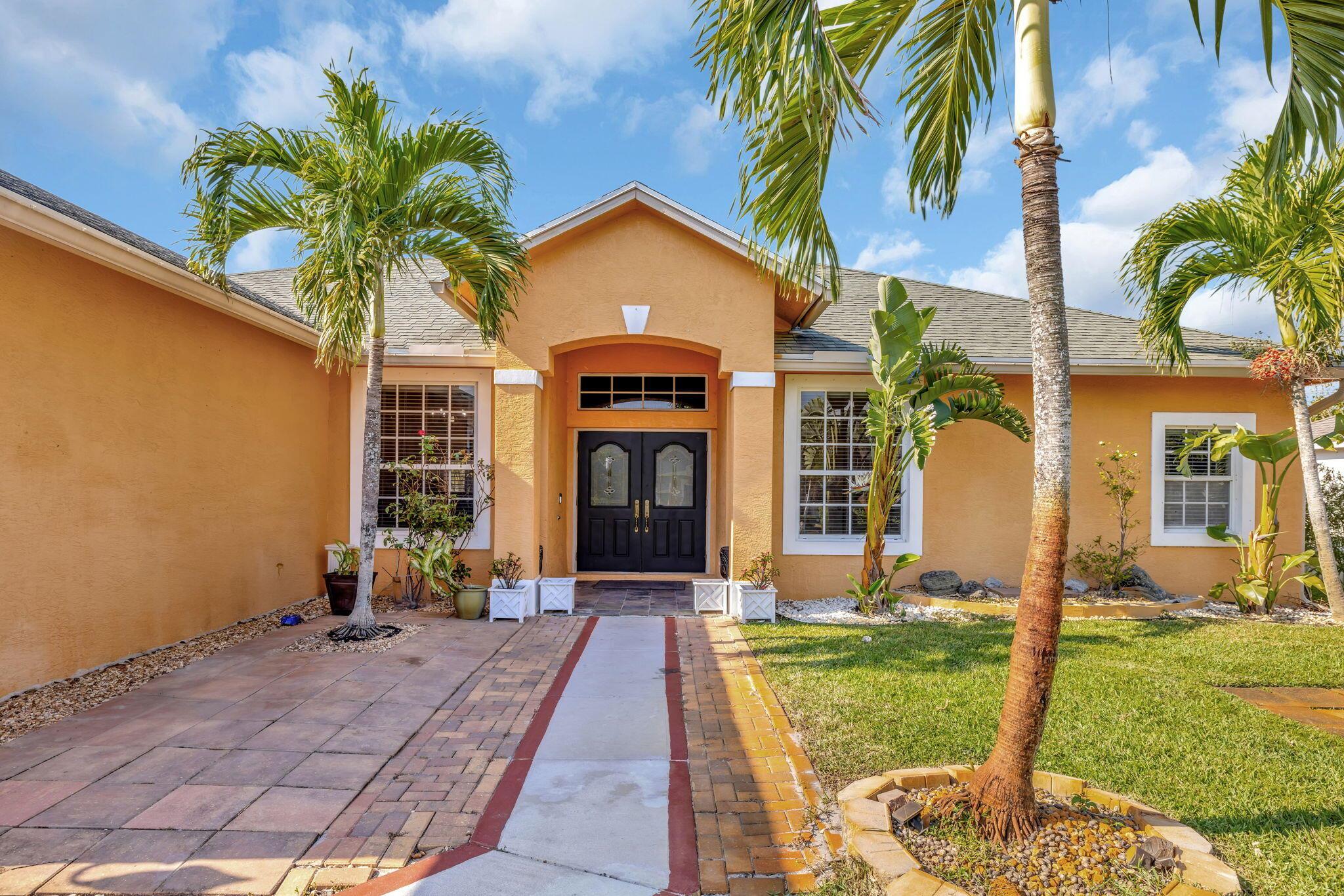 This beautiful 3BR, 2BTH CBS home with den/office in Port Saint Lucie near Becker awaits you. There is tile throughout main areas with wood laminate in secondary bedrooms and bamboo in Master. Black and stainless appliances in kitchen and a beautiful pantry. Once you enter the home you will see the open living room with formal dining area and breakfast/bar area off the kitchen. This home has vaulted ceiling with fans and HUGE Master B/R with his/her walk-in closet. Master bath has Roman tub, glass walk-in shower and dual sinks. Large screened tiled open patio, privacy fence. Quiet street and great location with easy access to I-95 & Turnpike. Great area with everything close by. Come see for yourself. make an appointment. Mature fruit trees. Mangoes and coconut