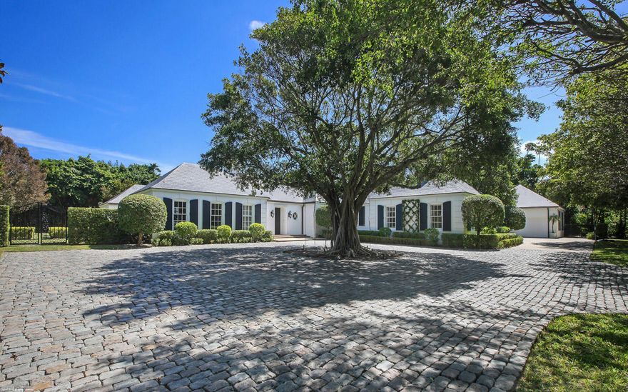 This beautifully designed, traditional Jupiter Island residence on almost a full acre (.94 acres) in prime club area location affords total privacy and features the best of tropical living. The 6000+ sq. ft. main house includes 4 bedrooms each with its own bath plus spacious living, dining and entertaining areas. There is a 1600+ sq. ft. 3 bedroom guest cottage complete with a separate living/dining room and enormous kitchen and laundry room. All of this is surrounded by lush green formal landscaping anchored by old growth trees and specimen palms. Special features include Vermont slate roof, antique Belgian block driveway and Mexican river stone pool.