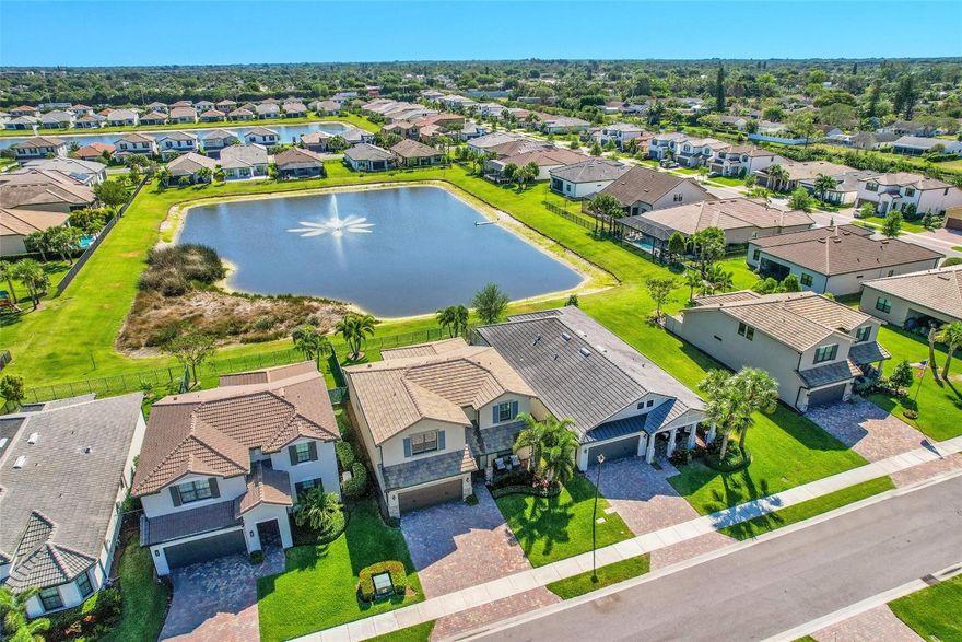 Best view in the Neighborhood! Built in 2022 gorgeous 4 bedrooms + office + loft, 2.5 bathrooms, 2-car garage single-family home in the highly desirable community of The Fields. This Citrus Grove model facing East, on the lake is one of the largest in the area, featuring modern elegance, expansive living spaces, with over $150k of luxurious upgrades. The lower level includes an open-concept living, kitchen, and dining area. Additionally, the master bedroom and an additional bedroom/office  are situated on this floor. Upstairs you are welcomed by an exceptionally spacious loft area, which leads to three big bedrooms, each with their own walk-in closets. Extended covered patio with electric screen overlooking lake and fountain. Extended driveway. List of upgrades available upon request. List of upgrades attached