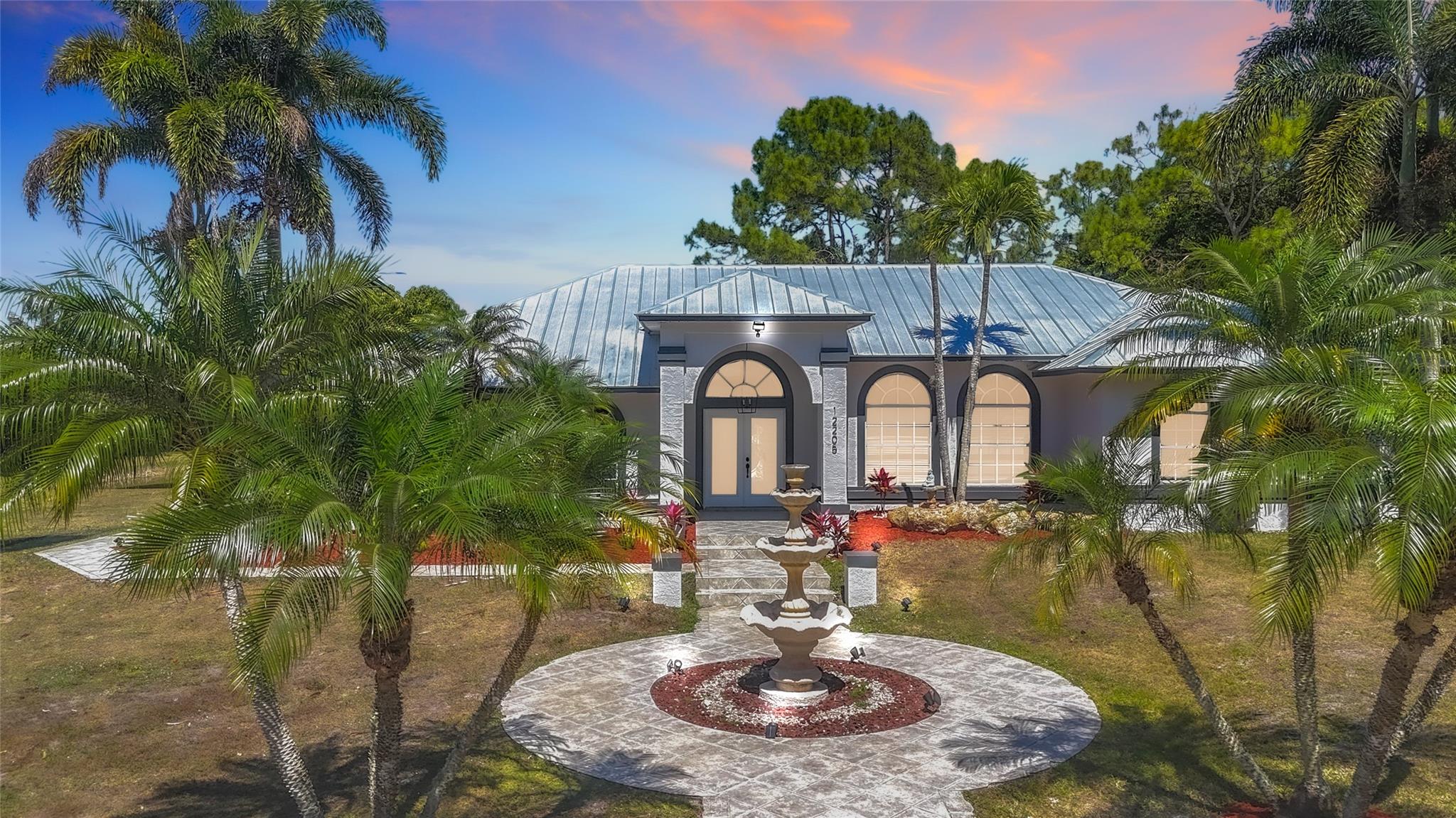 Welcome to this Impressive Estate in the heart of The Acreage. Featuring a total of 5 bedrooms, 3
baths, an enclosed Cascade Pool area & your own Private Lake. Sitting on a massive oversized 1.7 acres Lot. 2023 Metal Roof with 10 year warranty. Reverse osmosis water filtration system 2023. 2022 AC. The main home offers 3 bedrooms, 2 baths, separate Dining & Living area plus a Family Room. The adjacent in-laws suite offers 2 beds, 1 bath plus its own separate entrance and bonus kitchenette area. Perfect for additional income, large families, or a Home Office space. No HOA! Fully paved street access from both the front and back of the property. Bring your Boats, Trucks, Trailers, RVs, as well as your horses, swans, chickens, plants, and more. Call today to make this Estate your future Home.