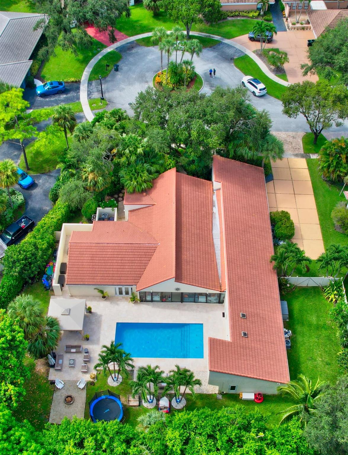 Completely unique Estancia North estate unlike any other home in the community. 5 bedrooms, 3.1 baths, 2 car garage. 1 bedroom converted to a media room. Amazing architectural detailing. Beautifully updated home on an immense lot with a salt chlorinated pool. Lush landscaping in a park-like setting with mango & banana trees. The open floorplan is filled with light and luxury that seamlessly connects all the living areas. 2 kitchens will accommodate any of your special needs. Spiral staircase leads to the private 2nd floor office. Many upgrades. including impact glass windows & doors, high end appliances, and summer kitchen. Underground propane gas tank. Ideal central Boca location--convenient to houses of worship, shopping, dining, A-rated schools & transportation.