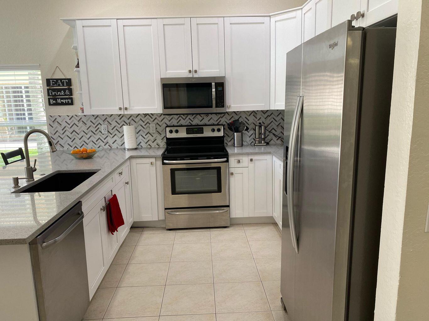 Discover this beautiful and spacious 1-story single-family home located in the desirable Nautica Isles neighborhood. This move-in ready home features an updated kitchen with SS appliances, perfect for everyday living and entertaining. The master bedroom offers his and hers closets for ample storage, while the open layout provides a comfortable and functional living space. Step outside to a covered patio with stunning lake views, ideal for sipping your morning coffee as the sun rises or enjoying dinner alfresco with serene waterfront scenery. Residents of Nautica Isles enjoy resort-style amenities including a community pool, fitness center,& more.Conveniently located near I-95 and the Turnpike, just 12 miles from Palm Beach International Airport Don't miss this  OPPORTUNITY !