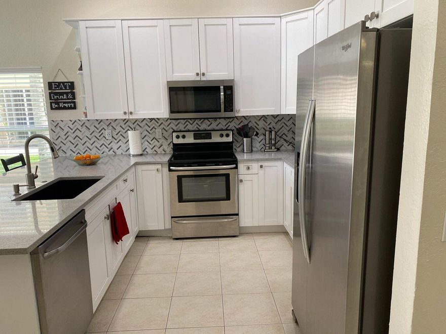 Discover this beautiful and spacious 1-story single-family home located in the desirable Nautica Isles neighborhood. This move-in ready home features an updated kitchen with SS appliances, perfect for everyday living and entertaining. The master bedroom offers his and hers closets for ample storage, while the open layout provides a comfortable and functional living space. Step outside to a covered patio with stunning lake views, ideal for sipping your morning coffee as the sun rises or enjoying dinner alfresco with serene waterfront scenery. Residents of Nautica Isles enjoy resort-style amenities including a community pool, fitness center,& more.Conveniently located near I-95 and the Turnpike, just 12 miles from Palm Beach International Airport Don't miss this  OPPORTUNITY !