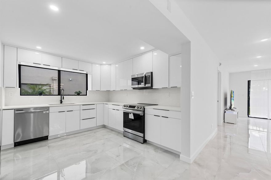 Gorgeous and fully remodeled 2-bedroom, 2-bath condo with den/office (or optional 3rd bedroom) in the desirable 55+ Lakes of Delray community, Pembridge E section. This 2nd-floor unit with lift access features elegant porcelain floors, recessed lighting, and a spacious kitchen with abundant cabinetry and stainless steel Samsung appliances. Both bathrooms offer stunning oversized showers. Enjoy peaceful canal views from the front and relax near the satellite pool. Includes stacked washer/dryer and furniture negotiable. Gated community with pickleball, tennis, gym, library, theater, and more--just 15 minutes to the beach!