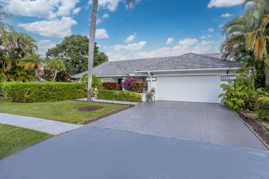 Stunning Lakefront Pool Home in Sun Valley - 3BR/2BA | 2,300 Sq Ft, Discover the ultimate South Florida lifestyle in this magnificent 3-bedroom, 2-bathroom lakefront pool home in desirable Sun Valley, Boynton Beach. This meticulously maintained 2,300 sq ft residence is located near A-rated schools and within walking distance to houses of worship. The home features a striking entryway with floor-to-ceiling mirrored walls and soaring vaulted ceilings throughout. The open floor plan showcases neutral tile and plush carpeting, with a step-down family room and oversized windows capturing breathtaking lake views. The bright kitchen boasts all-white cabinetry, clean countertops, complete appliance package, and tropical-motif accents. The master suite features wood flooring and generous closets, while two additional bedrooms offer flexibility for guests or home office. The spectacular outdoor oasis features a stunning kidney-shaped pool with integrated spa, covered patio for entertaining, and peaceful lake views framed by mature tropical landscaping. Two-car garage and paver driveway complete the exterior. Sun Valley is one of Boynton Beach's premier family-friendly neighborhoods with A-rated schools, walking distance to worship, and easy access to beaches, downtown Delray Beach, shopping, and major highways. Don't miss this rare lakefront opportunity!