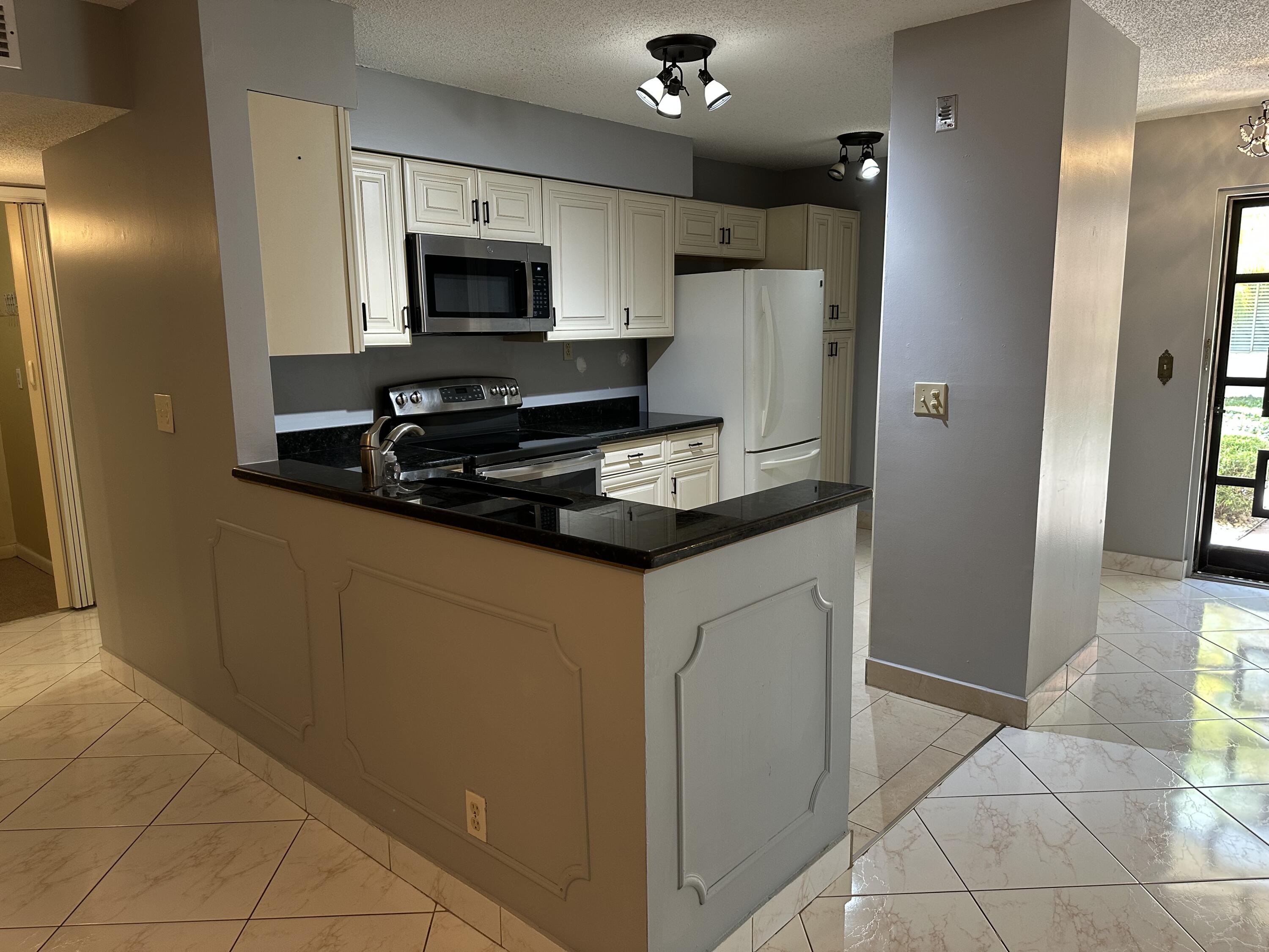 Lovely 2 Bed 2 Bath condo with washer/dryer on the 1st floor in 55+ community!! Beautiful condo, spacious with open floor plan allowing for lots of natural light and includes some great amenities such as: tile floors throughout, freshly painted, open kitchen with granite countertops and oversized kitchen cabinets, nicely updated bathrooms, oversized master closet, privacy shutters, plus washer/dryer and storage room. The unit is overlooking serene garden where you can enjoy the afternoon sunsets and is steps away from the pool and car wash. Located just minutes from downtown Delray and beach, shopping, entertainment, great dinning, and good hwy access to i95 & Turnpike. Come see it, will not last!