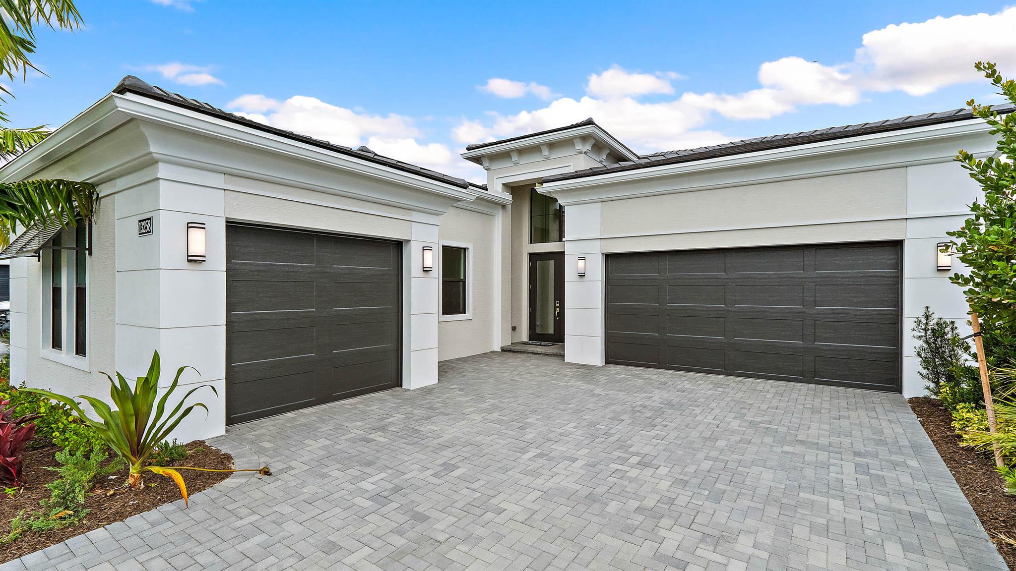 *NEW CONSTRUCTION* Move-in ready new construction by Kolter Homes featuring the Michelangelo floorplan on a preserve homesite in the gated community of Artistry Palm Beach. This single-story home offers three bedroom suites, three full bathrooms, one half bath, and a split three-car garage. Interior upgrades include custom lighting, decorative wood beams in the foyer, tray ceilings, insulated impact glass, and spray foam insulation. The kitchen is equipped with gas cooking, a 48'' Monogram refrigerator, wine reserve, quartz backsplash, 3'' quartz island, second-tier upper cabinets, crown moulding, and a cabinet panel package. The owner's suite features a freestanding soaking tub and an expanded walk-in closet.
