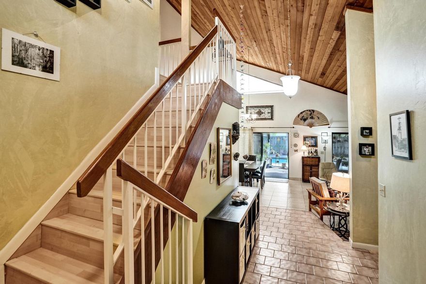 Spacious 2-story home, with true 4 bed & 4 bath and 5th room that can be  bedroom/playroom/den. Soaring vaulted ceilings with rich wood planking anchor the grand living and dining area, filled with natural light from large windows and sliding doors leading to the screened patio. The eat-in kitchen features ample cabinet space, newer stainless steel appliances, and a garden window overlooking the backyard. The oversized primary suite boasts hardwood floors and a luxurious en-suite with cobalt blue tile, soaking tub, double vanity, and separate shower. Additional bedrooms are generously sized and updated bathrooms in rest of the home. Outside, enjoy a large pool and deck, screened patio, and lush tropical landscaping. Roof done in 2018.  All info believed to be accurate but not warranted.