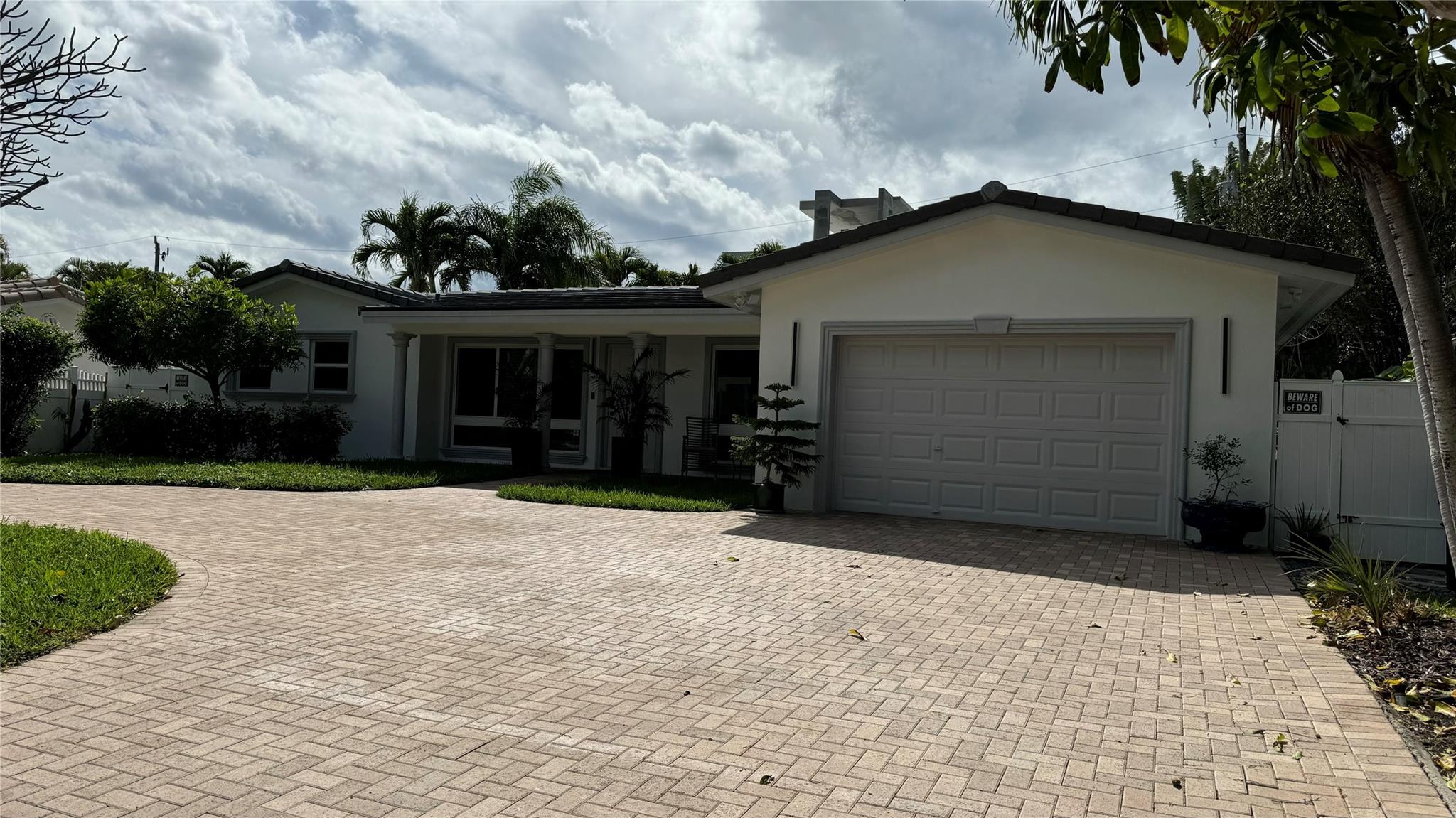 Private beach access. Coastal retreat home in upscale Hillsboro Shores, Pompano Beach, Florida. This is a turnkey home with the perfect blend of modern luxury and seaside charm. As you step thru the front door, you're greeted by an open-concept living space bathed in natural lights with strategically placed windows that frames beautiful views of the pool. Hurricane windows and doors plus New roof in 2023. The chef's kitchen with black stainless steel fingerprints free appliances. Waterfalls quartz countertops with custom made cabinetry. Beautiful porcelain floors throughout the house. New Podocarpus trees for privacy in backyard featuring a covered patio for dining or sunset cocktails by the heated/salt water pool. Pool was fully renovated in January 2025. Voluntary HOA. Bring your offer!
