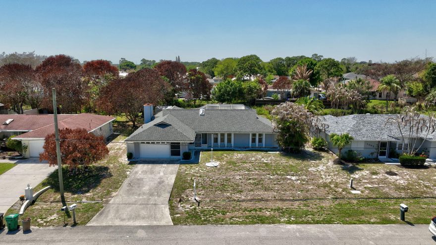 Great opportunity to own a Pool Home with No HOA! This CBS construction (lower insurance) home offers: 3-BD 2-BA 2-Car Garage, 1744 SF (living) and 2640 SF (total), New roof in 2023, A/C 2021 and serviced electrical panel in 2019. Inside it offers, formal dining room, living room with wood fireplace and vaulted ceilings, Kitchen with pass-thru window overlooking the pool, plenty of cabinetry, pantry. Washer, Dryer and laundry tub in the garage. Two Sky lights provide extra natural light. Outside it offers: 36'x12' lanai, a spacious screened pool patio, Hurricane accordion shutter throughout the house for your comfort and safety. Convenient to local stores, Supermarket, Restaurants, public schools, I-95, FL Turnpike. Only minutes to Jensen Beach & Boat launch ramp. Welcome to FL lifestyle!