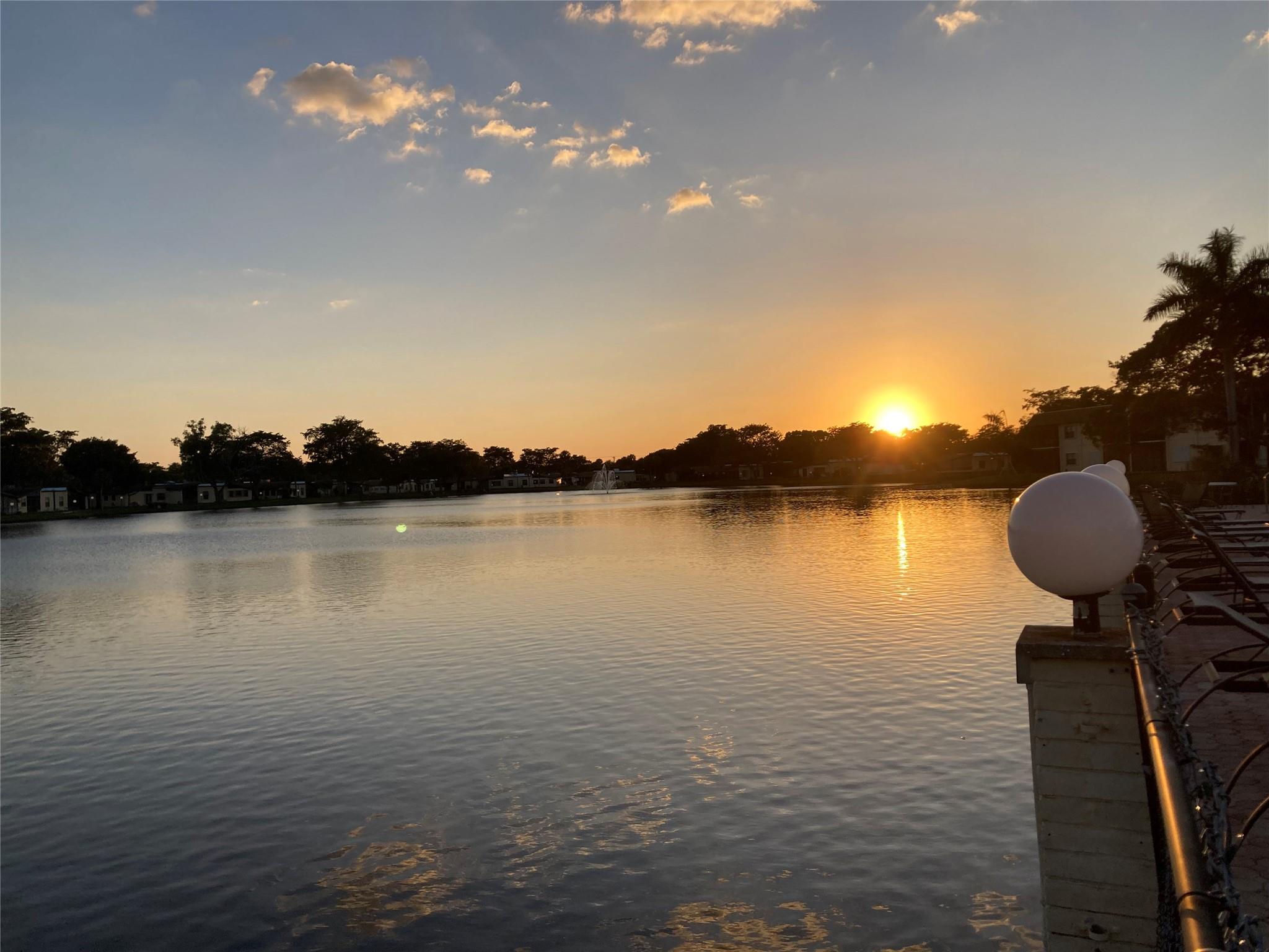 Enjoy every day the sunset from the pool...and also the beautiful lake view in this quiet neighborhood. This is a Fantastic 2/2. The bathrooms are renovated. as well the kitchen countertop. The property features tiled flooring and is freshly painted. The closet space is wonderful. 24-hour security, gate community, courtesy bus, fantastic pools and tubs with beautiful view over the lake, 4 tennis court, and a gym. Equal Housing Opportunity