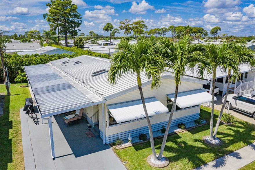 Must see this recently upgraded double wide manufacturer home, in 55+ Tropical Breeze owned deeded land. In great condition, very comfortable wide open space with many windows. The kitchen just been refresh with taste. new counter top, sink, faucet and cabinet. Cathedral ceiling throughout the house and warm engineered wood floor in main area. Large double solar room up front and bedrooms in the back 2/2. Long carport for your cars, Florida room with screen and windows and a oversize shed for all your projects. Back yard with a tall mature edge give you privacy area. Newer AC, appliances, plumbing and flooring. Just come see it, make an offer to make it yours.