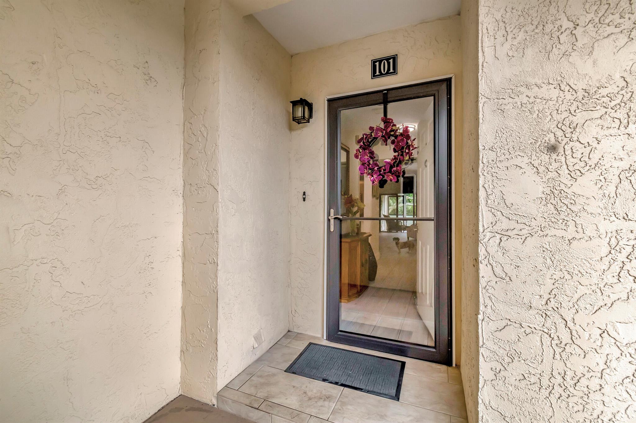 Welcome to your new condo in Ocean Parks, a tranquil, park like environment that surrounds this charming two bedroom, two bathroom first floor end unit. From the moment you step inside, you'll notice numerous upgrades. The open and spacious kitchen features white shaker-style cabinetry, quartz countertops, and stainless steel appliances. This condo boasts a split floor plan, with the primary suite highlighted by glass sliding doors that lead to a screened patio. This bright and airy condo is adorned with wood look tile flooring throughout, plantation shutters, upgraded baseboards, impact windows, updated bathrooms, no popcorn ceilings and more. Take in the serene landscapes behind the property while relaxing on your screened patio.