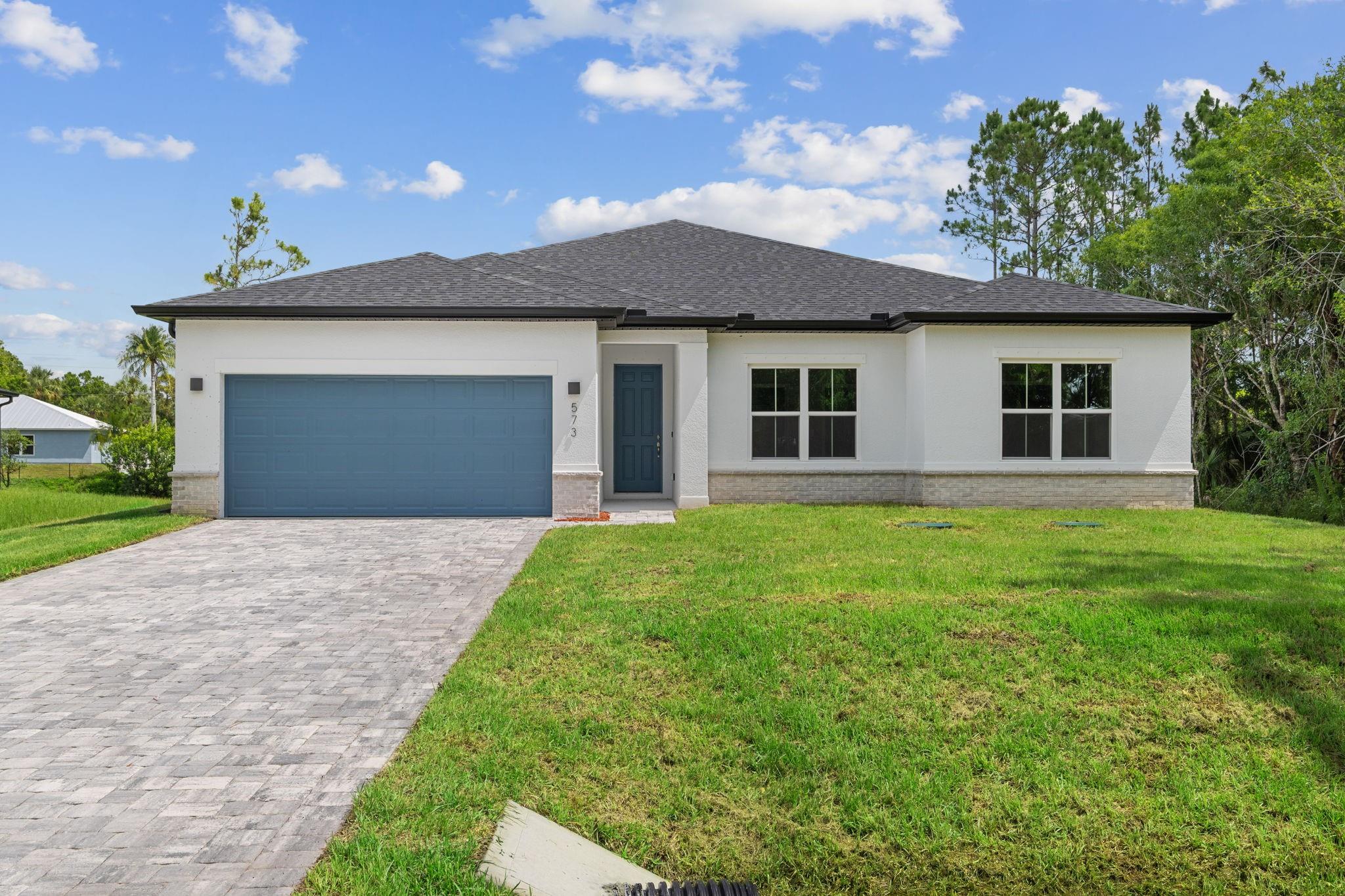 This exquisite 2,092-square-foot residence sits on a 0.24-acre lot fronting a beautiful, wide canal, offering stunning water views and breathtaking sunrises and sunsets. Designed for both comfort and elegance, the home features 4 bedrooms, 3 bathrooms, and a 2-car garage, setting a new standard for refined living. Step inside to discover premium finishes throughout. At the heart of the home is a chef’s kitchen outfitted with Samsung stainless steel appliances, a spacious center island, and striking Bengal Granite countertops paired with classic subway tile backsplashes. Beautiful Reef Gold vinyl plank flooring runs seamlessly throughout the home, replacing carpet. Soaring 9’4” ceilings enhance the airy atmosphere, highlighted by Maxim lighting fixtures and Moen Chateau Chrome accents.