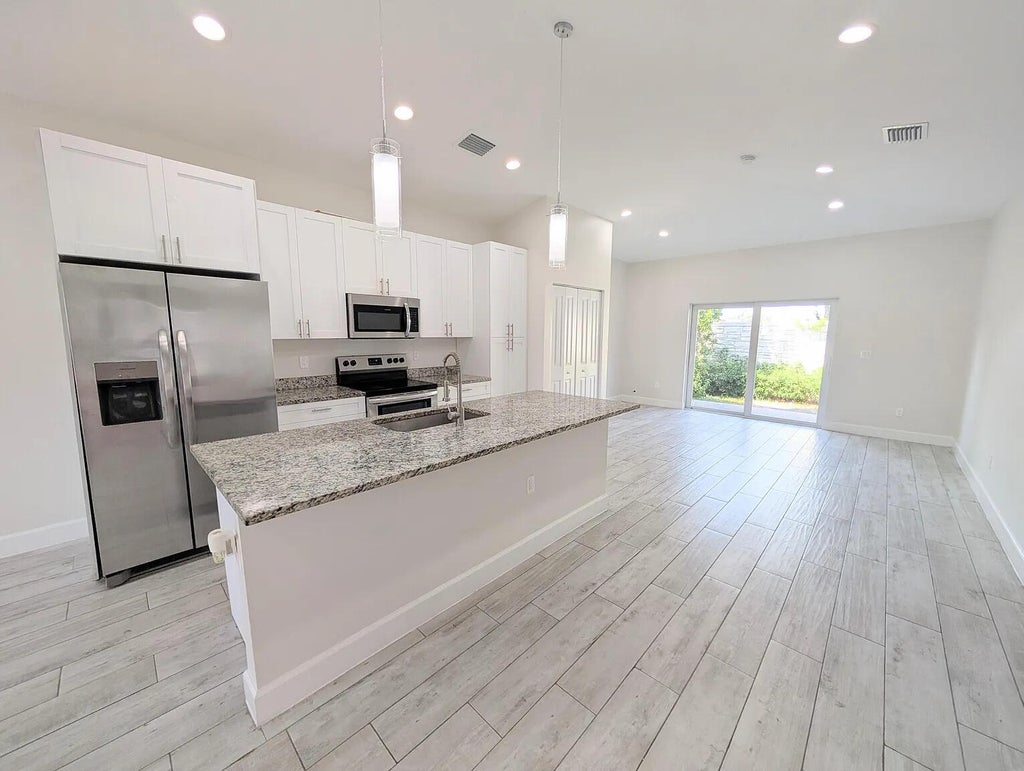 Photo of 1562 W 26th Court, Riviera Beach, FL 33404 (MLS # B26073938)