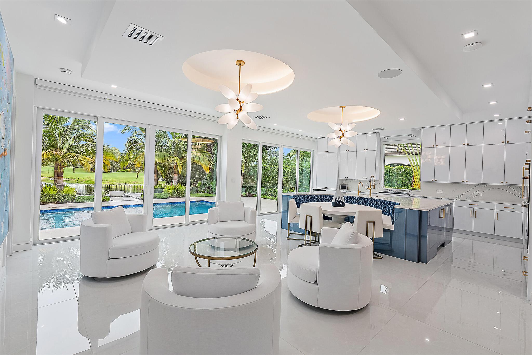 Welcome to this spectacularly reimagined residence in the exclusive Admirals Cove community--where impeccable craftsmanship, modern luxury, and serene water and golf course views converge. No expenses were spared in this beautifully renovated and expanded home featuring a luxurious primary suite, and designer-appointed bathrooms. The open-concept layout is anchored by a gourmet kitchen with a breakfast bar and an expansive great room--perfect for both relaxed living and elegant entertaining. Soaring ceilings, oversized windows, and abundant natural light create a bright, inviting atmosphere. Step outside to your private saltwater pool, surrounded by new pavers, lush landscaping, and unobstructed sunset views over the golf course.