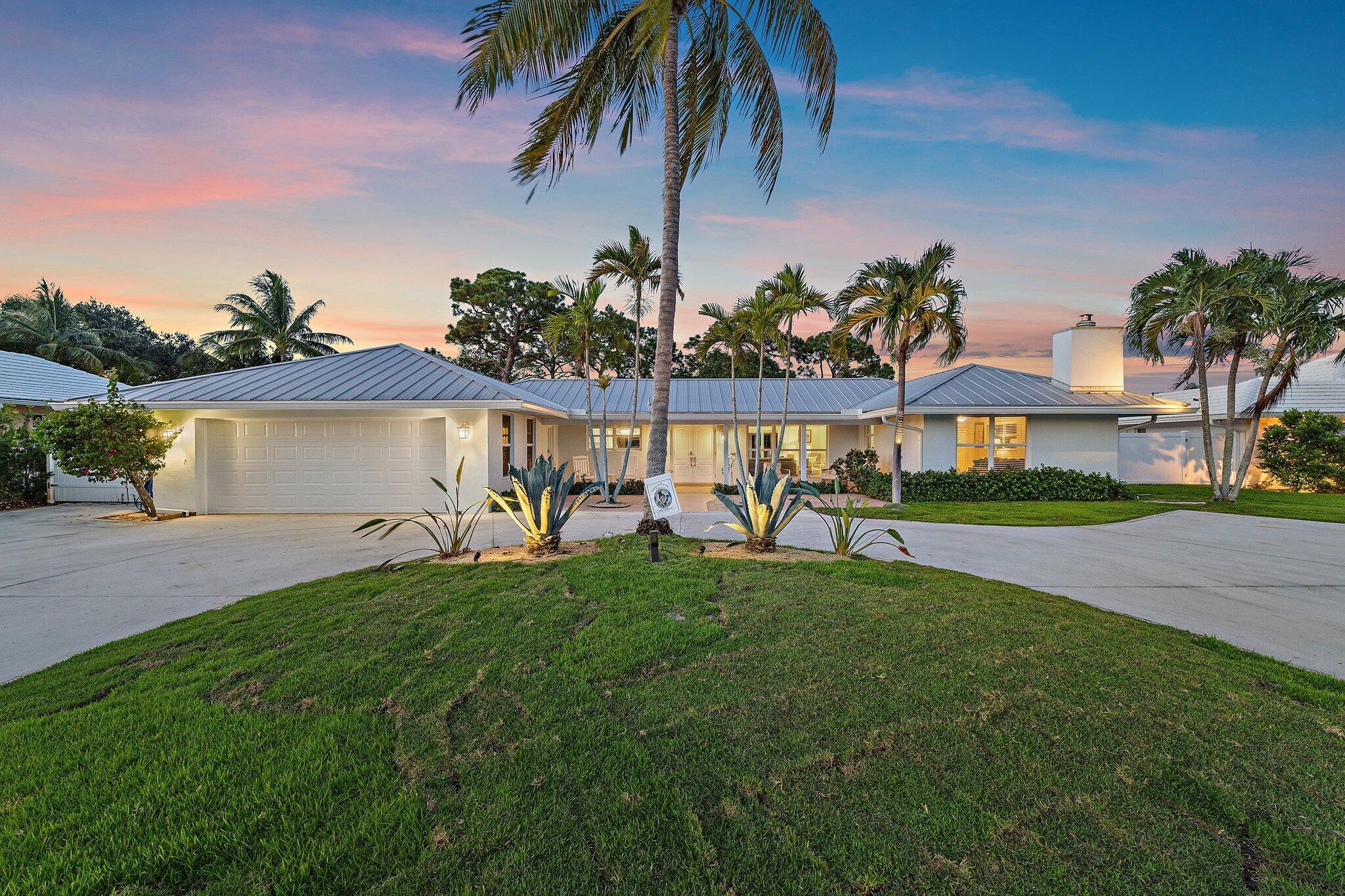 Panoramic golf course views from this beautifully remodeled 3-bedroom, 2.5-bath CBS pool home in highly desirable Tequesta Country Club--just 400 feet from the community boat dock and ramp. Situated on one of the largest lots in the neighborhood, this single-story property offers lush tropical landscaping, a fenced yard, and space to store a boat or RV. Inside, you'll find white oak wood floors, oversized bedrooms, and a functional split floor plan. One of the guest bedrooms features a cozy fireplace. The fully renovated kitchen includes new cabinetry, appliances, stylish lighting, and a built-in coffee/wine bar. All three bathrooms have been stunningly updated. Step outside to a newly resurfaced saltwater pool with a re-marsited finish, new pool deck, and outdoor shower.