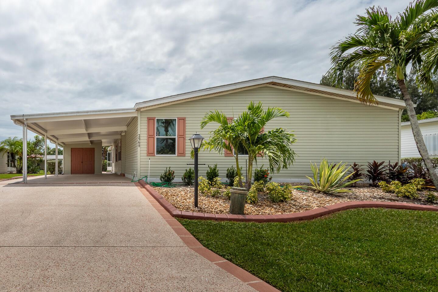 LIKE NEW-1790 sf Fully Furnished/Turnkey 3 BD/2 BA home. NEW A/C. New Roof Coming. Large Island kitchen. All new kitchen appliances, new granite thruout kitchen w/separate bar fridge/bar area. Large Double vanity en-suite w/soaking tub in Master Bath. Master has large closet w/built-ins. Large laundry room w/newer washer/dryer & large utility closet. Brand new luxury vinyl thruout except new carpeting in 2nd & 3rd bds. 30X12 screened-in lanai-furnished. All new landscaping w/new cement boarders & rock beds for super easy maintenance. Well water sprinkler system, fully updated & maintained thruout the yard for year-round, maintenance free watering. Oversized utility shed w/full electricity for all your storage needs. 3 large TVs up & running w/cable & internet included in HOA. Land Lease.