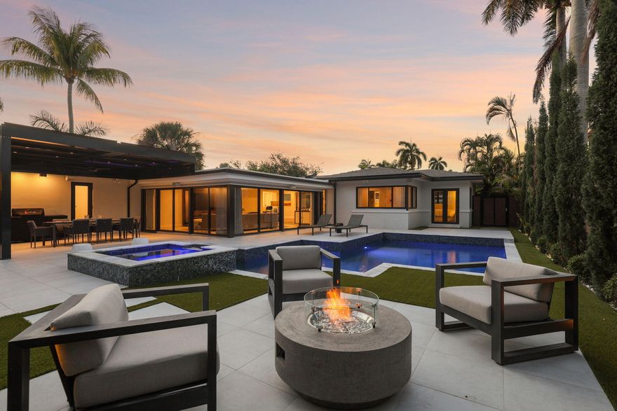 Welcome to 240 30th Street, a truly exceptional, designer-renovated residence in the heart of West Palm Beach. This 2-bedroom, 2.5-bath home with a versatile den (easily convertible to a 3rd bedroom) and 1-car garage has been professionally curated by an interior decorator and finished to the highest standards, blending luxury, comfort, and modern sophistication. Step inside to discover a bright, open layout featuring porcelain and wood flooring, custom drapery, designer lighting, and motorized blackout shades throughout. The stunning chef's kitchen is equipped with premium Thermador appliances, including a panel-ready refrigerator, gas oven, custom cabinetry, and sleek quartz countertops—perfect for both everyday living and entertaining. The spacious primary suite offers a custom  walk-in closet and a spa-inspired bathroom with dual sinks, a custom waterfall vanity, and a frameless glass walk-in shower. All bathrooms have been fully designer-renovated with high-end finishes. Enjoy seamless indoor-outdoor living with a beautifully landscaped, fully fenced backyard featuring yacht-style decking, porcelain pavers, and a $37,000 custom pergola. The resort-style pool and spa include a newer gas heater and Jandy equipment, complemented by a fully equipped summer kitchen with gas grill and refrigerator—ideal for entertaining year-round. Additional highlights include: • New concrete tile roof (1 year old) • Full-house 20kW Kohler generator • Impact windows and doors throughout • Tankless water heater (2025) • Dual A/C systems (7-8 years, meticulously maintained) • Rebuilt water filtration and softening system • Epoxy-coated garage floor • Circular stone paver driveway • Sonos outdoor sound system with 10 speakers + subwoofer • Ring security system with 6 cameras and spotlight features This move-in-ready home offers peace of mind with top-tier upgrades and systems, all thoughtfully designed for the ultimate South Florida lifestyle. Located just minutes from downtown West Palm Beach, dining, shopping, and pristine beaches—this is luxury living at its finest.