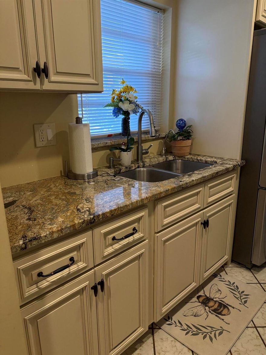 Rare opportunity to find a ground floor condo in Golfs Edge that is reasonably priced.  Sellers are eager to negotiate a fair price and a quick closing.  Kitchen and bathrooms are remodeled and ready for you to move in.  Park near your front door.  Enjoy sitting area outside among the tropical foliage.  Monthly fee includes building maintenance,  WPRF and water charges.