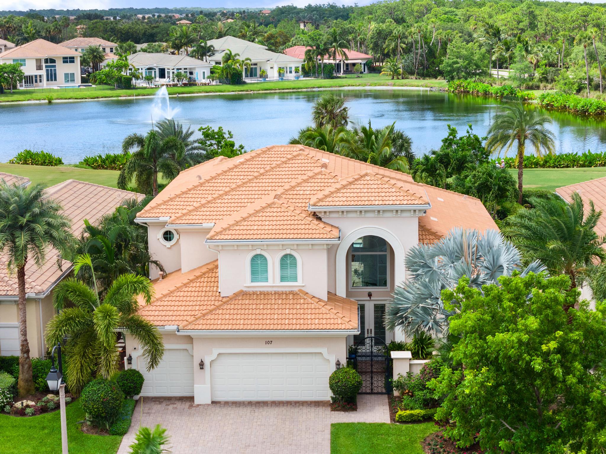 Stunning Estate Home with Social Membership in Jupiter Country Club. Discover the essence of luxury living in the Heritage Estates section of the Community. Offering captivating serene tropical water views, this meticulously maintained ''Portland model'' residence is peaceful and welcoming with a private gated entrance. Embrace a dream Lifestyle and Experience the perfect combination of comfortable interior living and serene outdoor tranquility. Whether relaxing by the pool, memorable gatherings, or enjoying the natural beauty surrounding your home, this exceptional property promises a life of serenity. The spacious floor plan, features 4 bedrooms with ensuite bath and walk-in closets, cabana bath, powder room, office, loft and generous living space. The secluded spacious owner's suite ha