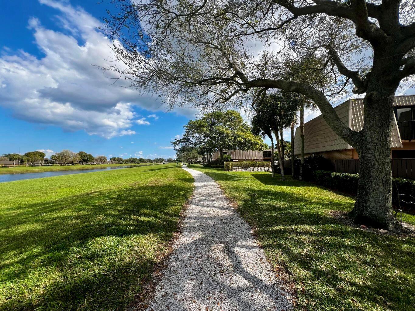 Move into this charming 2-bedroom, 2.5-bath townhome in the highly desirable Village of Sandalwood Lakes South. This inviting residence offers a spacious living room, dining area, and kitchen with tile flooring, creating a warm and welcoming atmosphere. A full-size washer and dryer on the main level add convenience. Upstairs, both bedrooms feature ensuite bathrooms and private balconies. Enjoy a large patio space, assigned parking, and guest spaces. The community offers fantastic amenities, including walking trails, picnic areas, three pools with clubhouses, playgrounds, and sports courts. Conveniently located near I-95, downtown West Palm Beach, The Square, Tanger Outlets, and PBI Airport.
