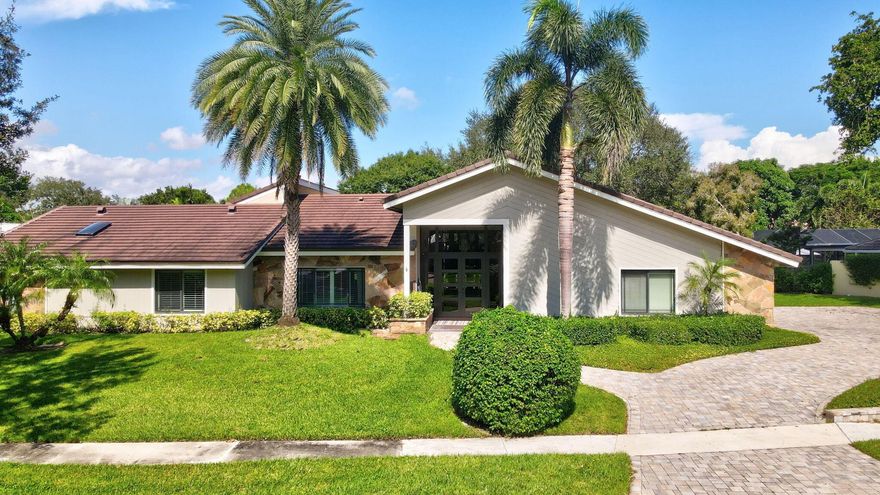 Discover one of Boca Raton's most desirable locations- Boca Bath & Tennis - enjoy the privacy, security and prestige of this gated tennis community. Ideally situated near top-rated schools, including the new Blue Lake Elementary, fine dining, the beach, and world-class shopping at Town Center Mall, this spacious one-level home offers almost 4,000 sq/ft of living space on an oversized lot. Perfect for entertaining, the open layout features expansive living areas, vaulted ceilings, and newer impact windows and roof. The split-bedroom design includes a private primary suite with a large bathroom and separate office that opens to a secluded yoga patio-ideal for workouts or relaxation . On the opposite wing, you'll find three additional bedrooms and 2 full baths. The kitchen is equipped with