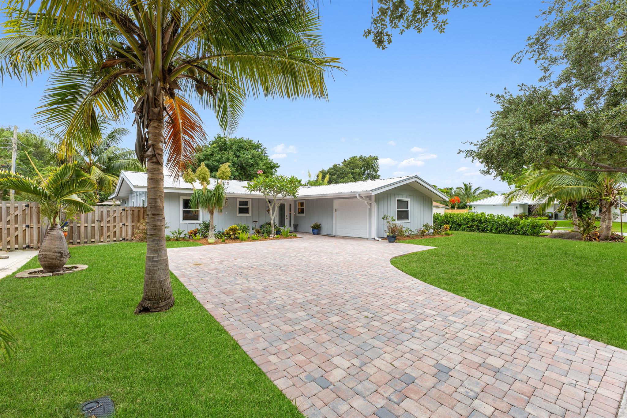 Paradise in Tequesta with no HOA! One block to the Intracoastal and minutes to beaches. Updated open kitchen with beverage fridges, modern baths, impact windows and doors, 1-car garage, inside laundry. BONUS ROOM (not in bedroom count) ideal for office, gym, or art. Large yard with room for a pool, plus a screened patio perfect for gatherings. Roof 2017, HVAC 2016 with new A-coils, 2025 water heater. Solar panels paid off at closing, current bills under $30/month with no loan. Corner lot with spacious side yard offers opportunity to fence in the entire area. Short-term rental friendly, massive open living space, move-in ready!